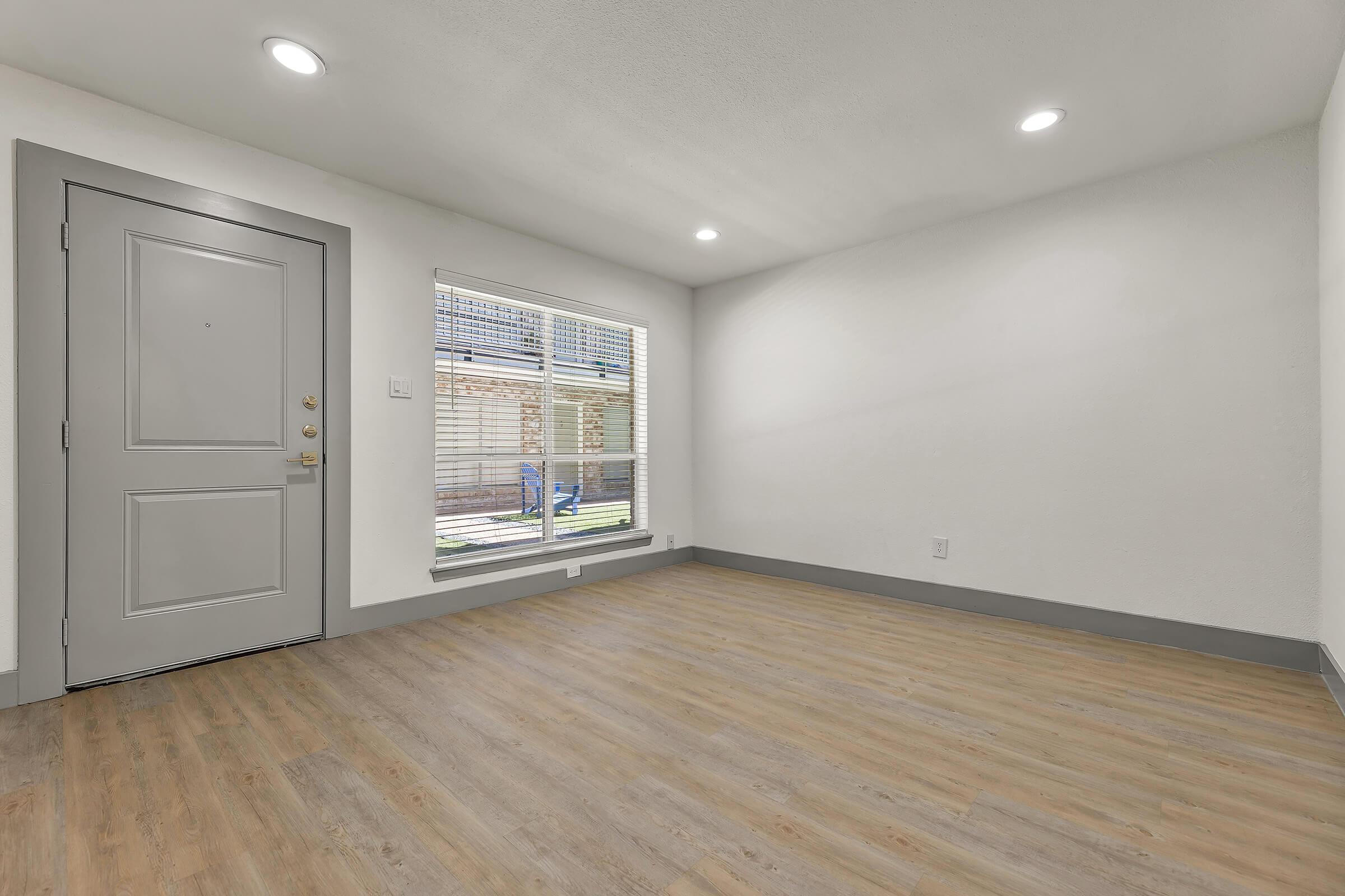 a large empty room with a wooden floor