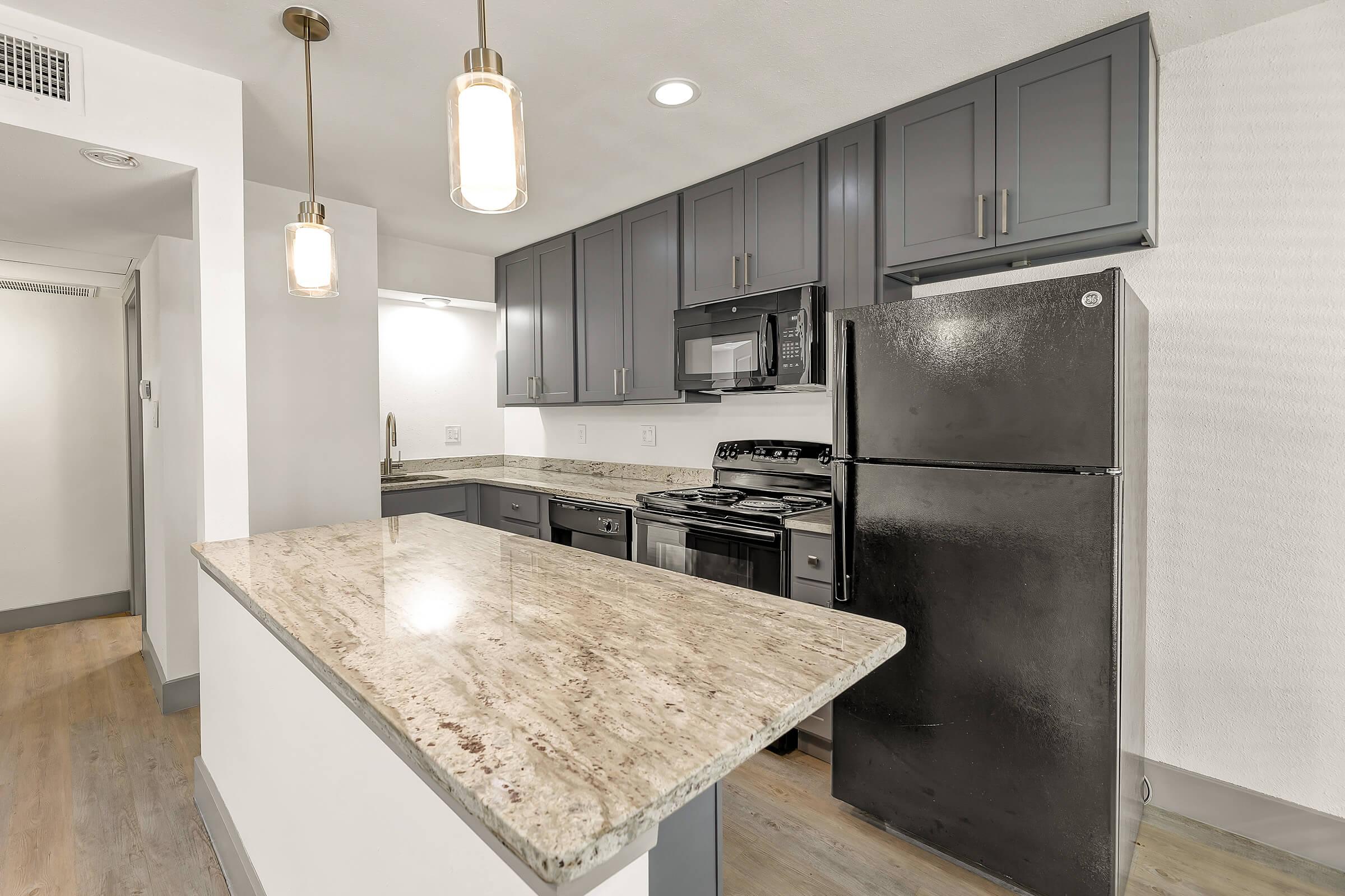 a kitchen with a sink and a mirror