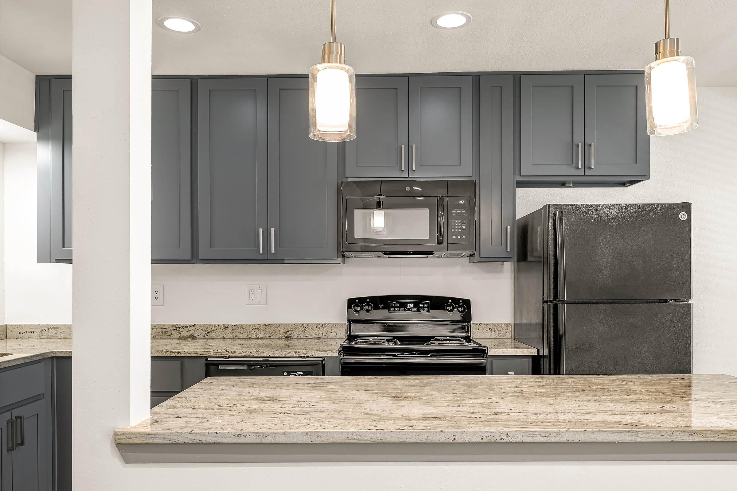 a kitchen with a sink and a mirror