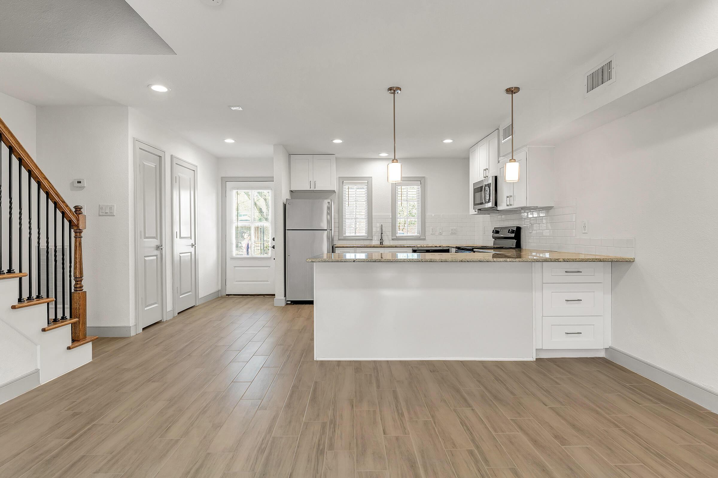 a kitchen area with a building in the background