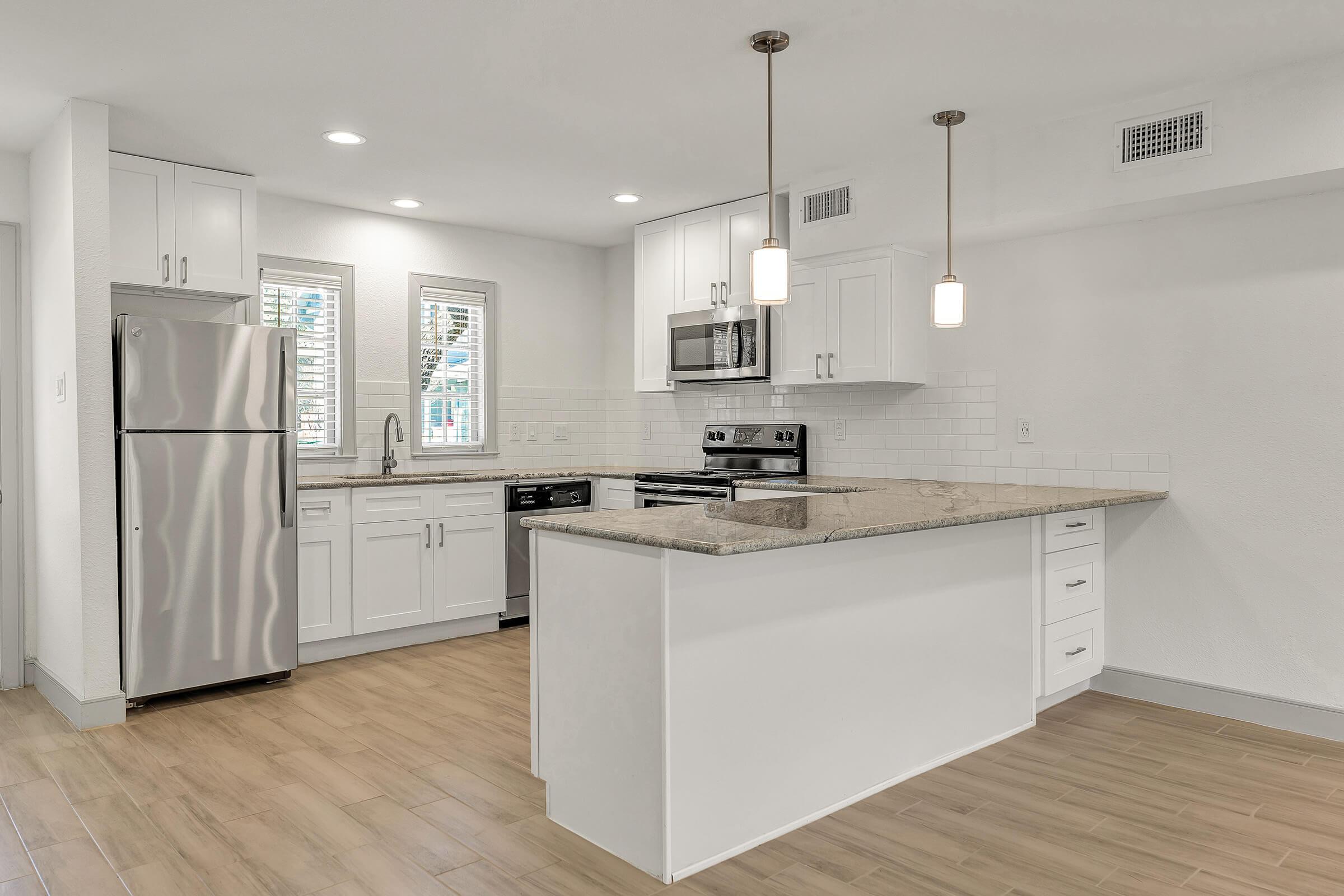 a kitchen with a sink and a refrigerator