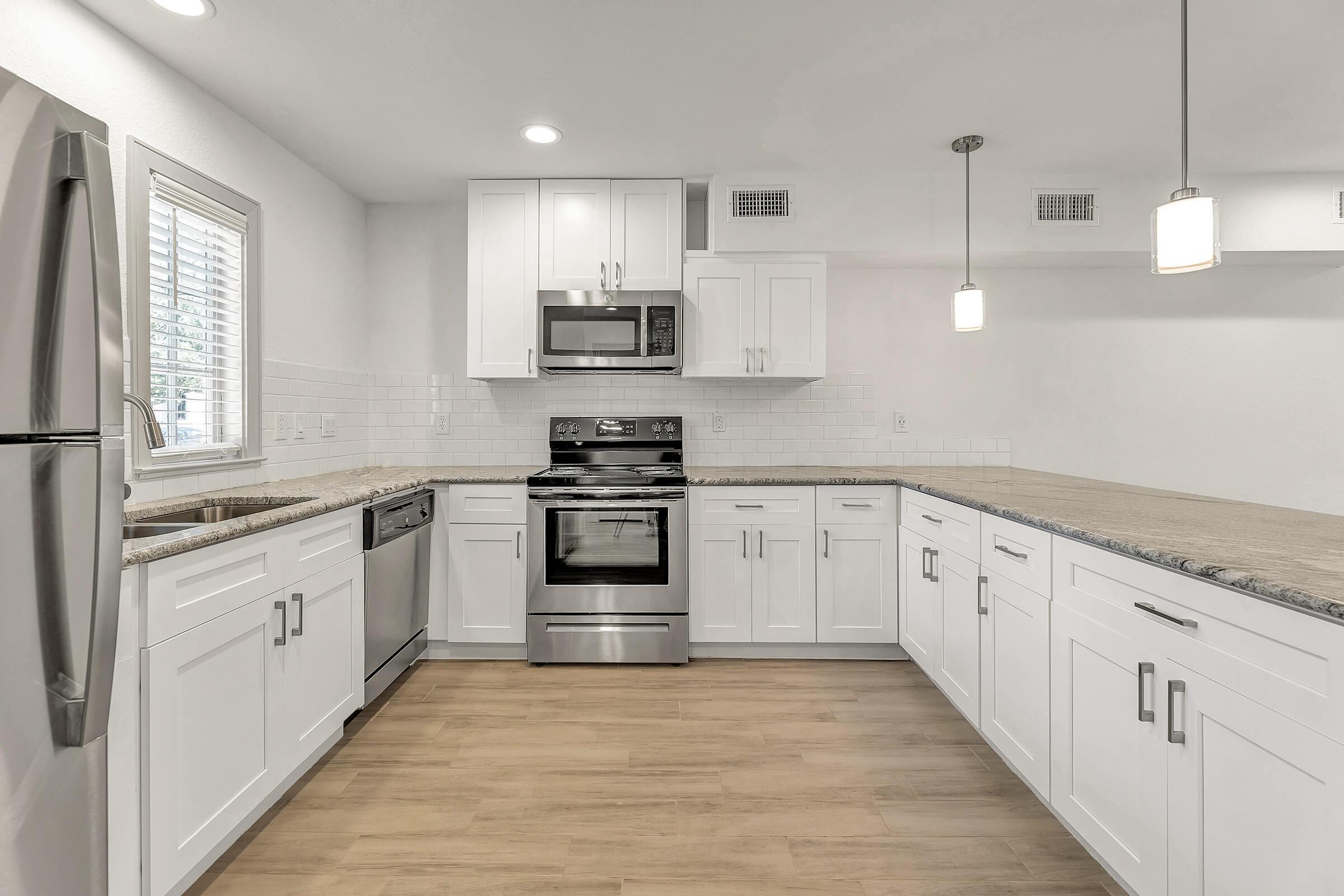 a large kitchen with stainless steel appliances