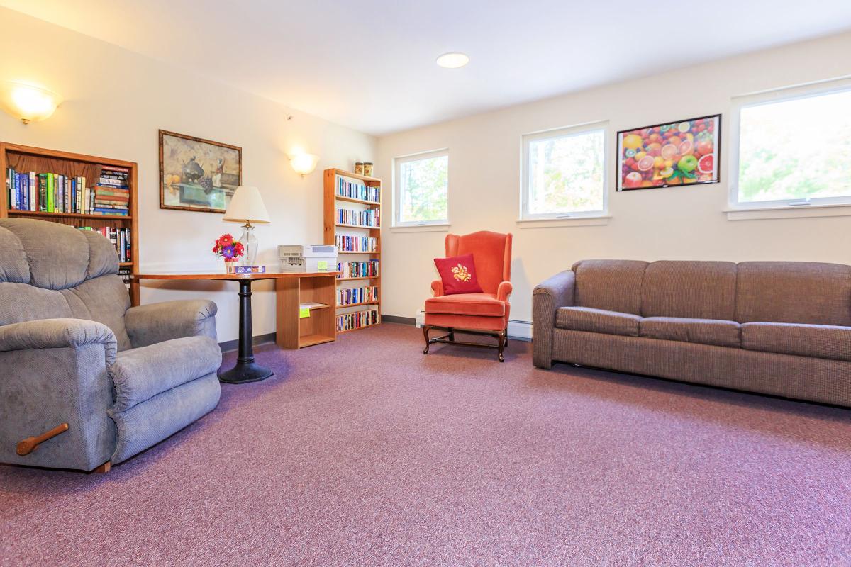 a living room filled with furniture and a flat screen tv