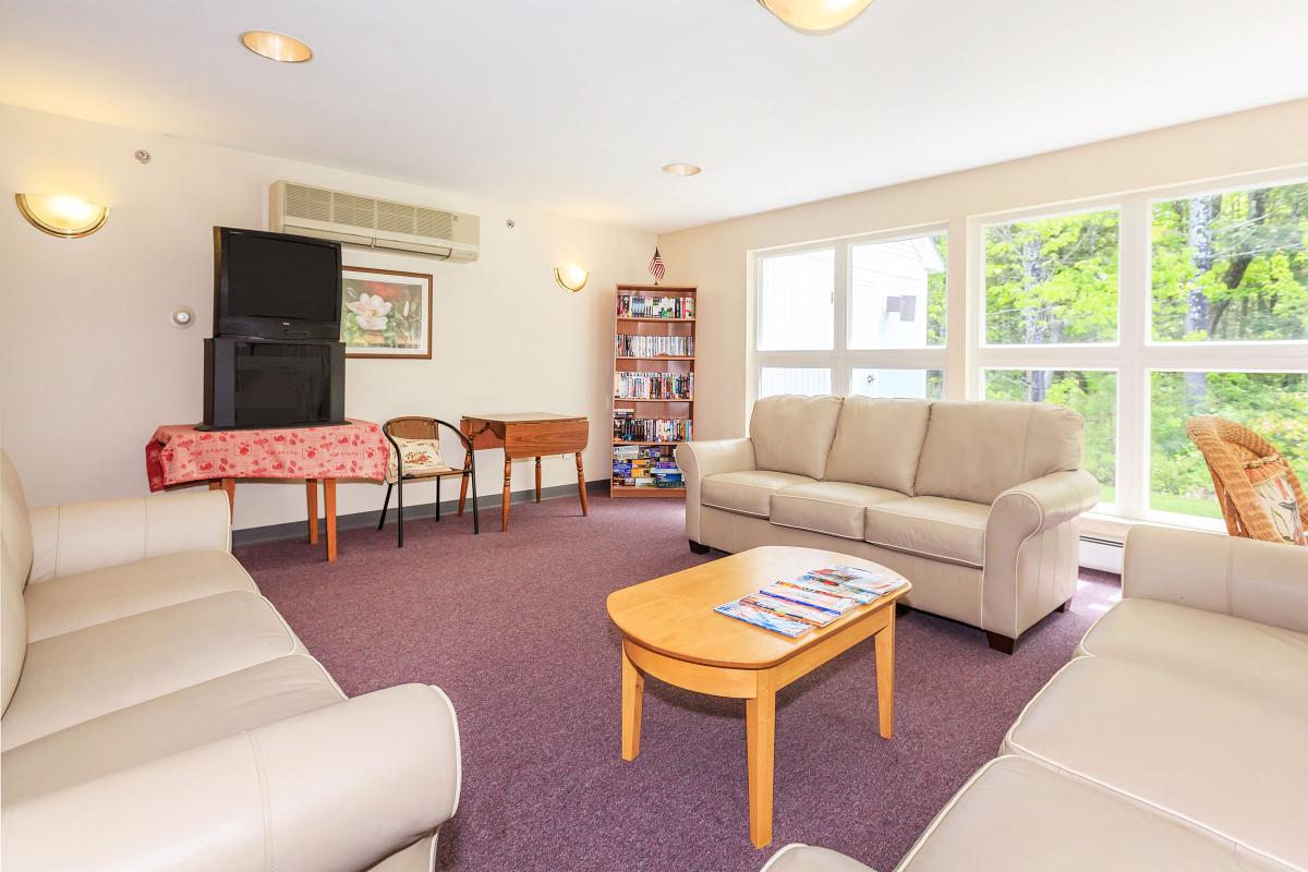 a living room filled with furniture and a large window