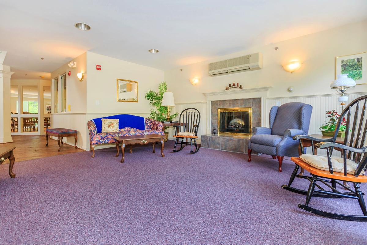 a living room filled with furniture and a fireplace