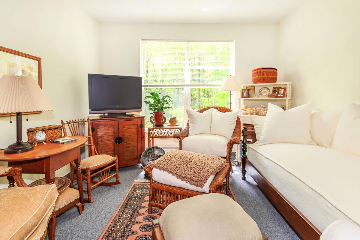 a living room filled with furniture and a flat screen tv