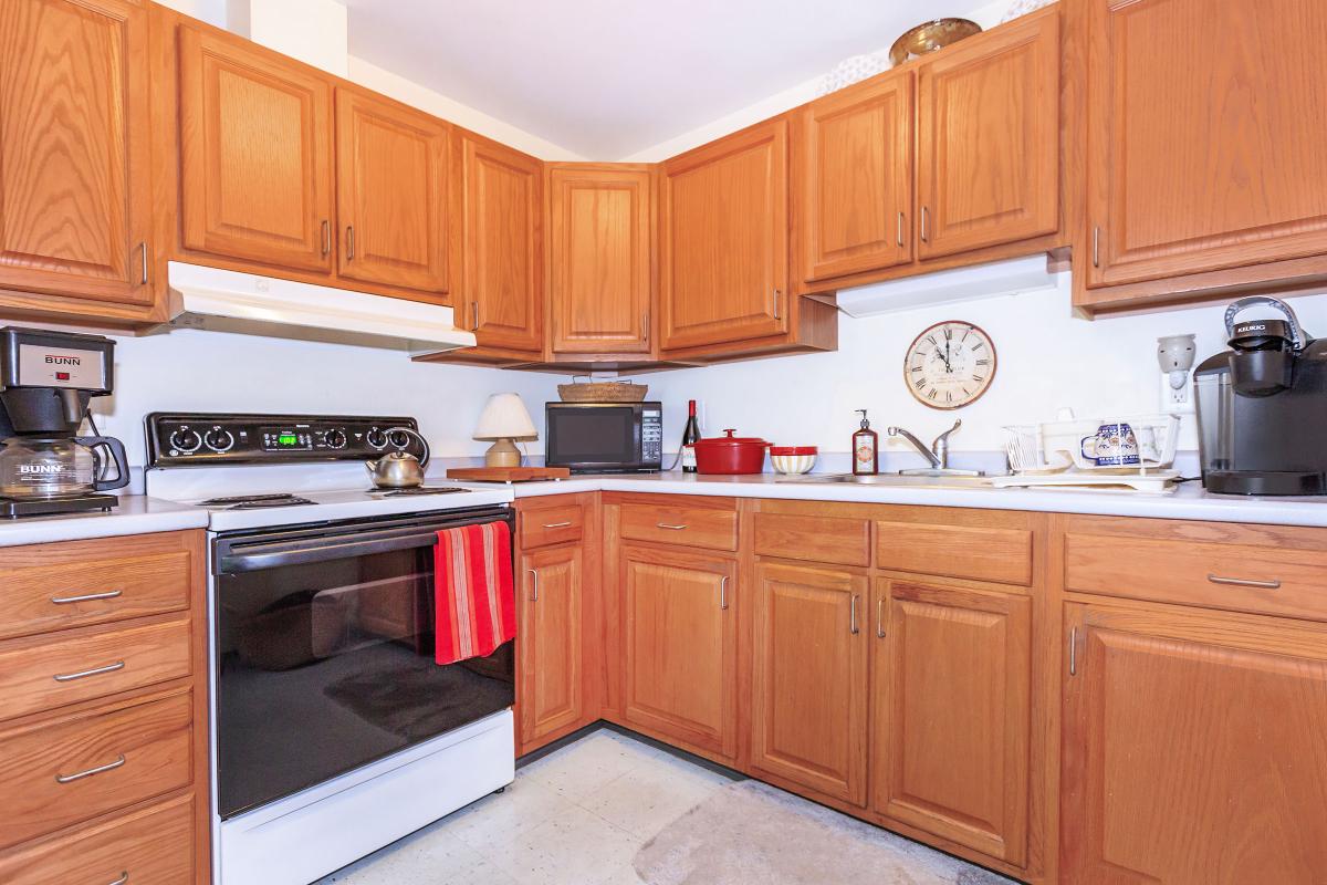 a kitchen with stainless steel appliances and wooden cabinets