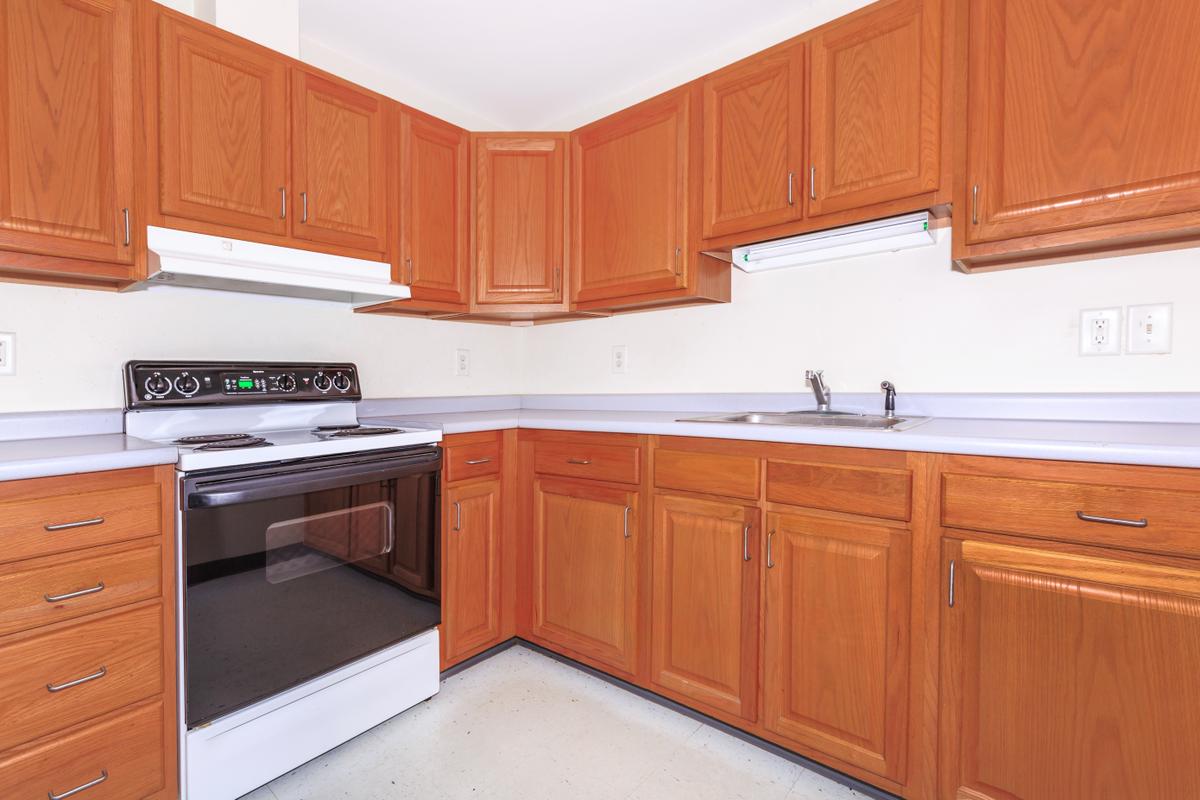 a kitchen with stainless steel appliances and wooden cabinets