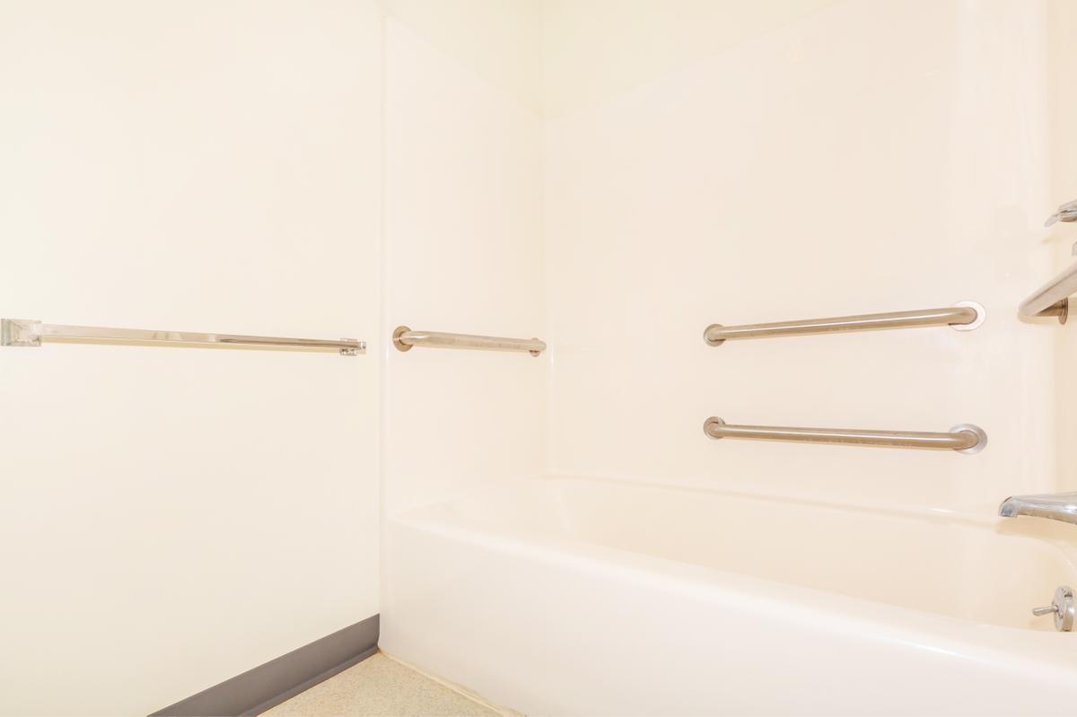 a white tub sitting next to a shower