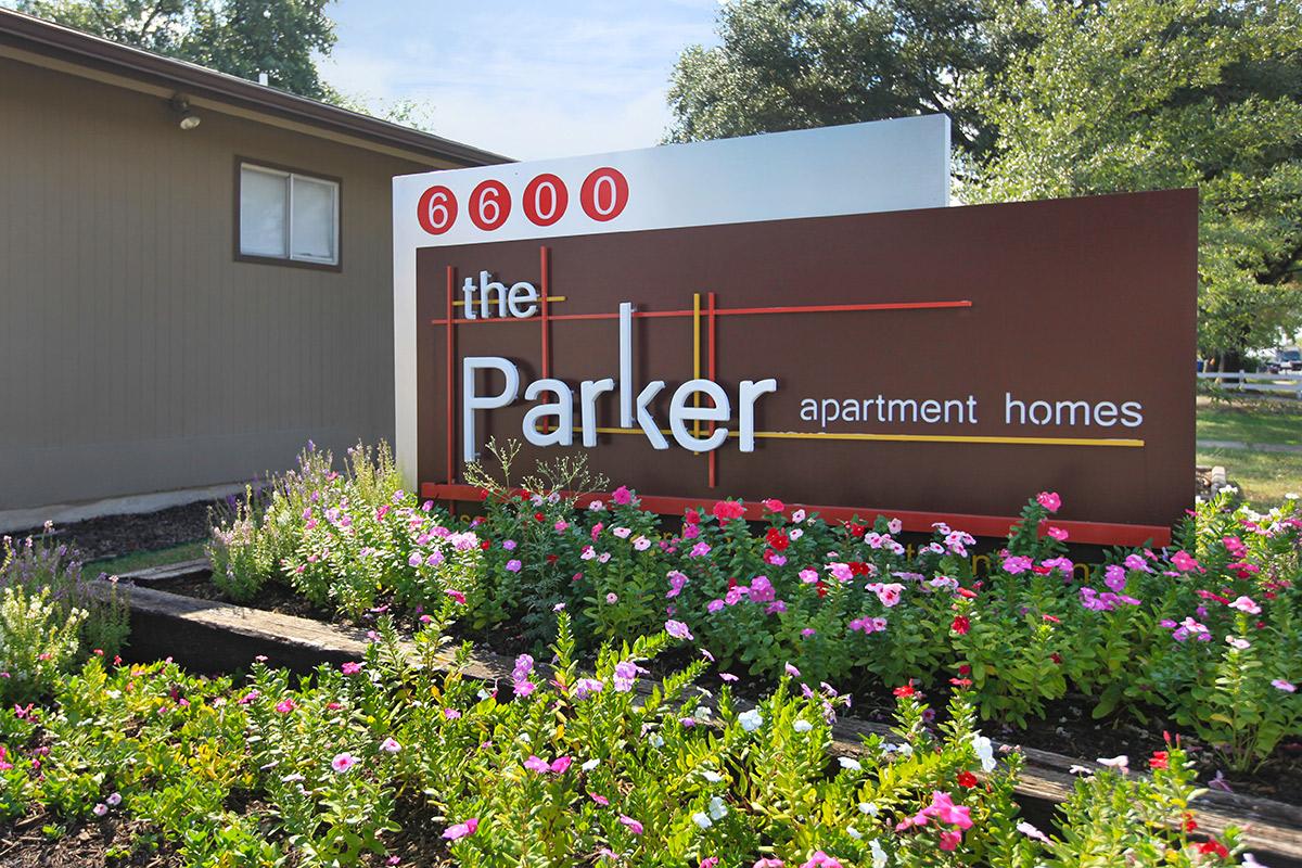 a close up of a flower garden in front of a building