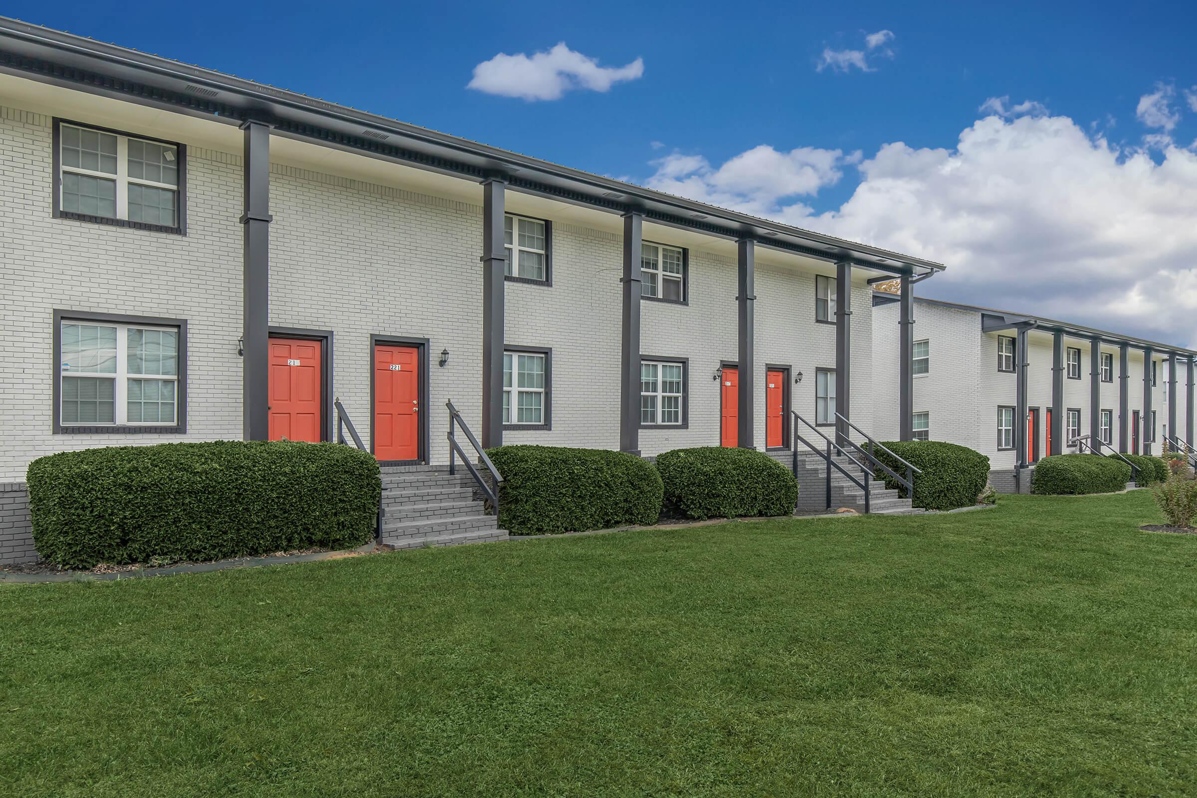 Elements44 Townhomes' 2 Bed 1.5 Bath brick homes with 2 buildings and the landscaped with green grass and green bushes