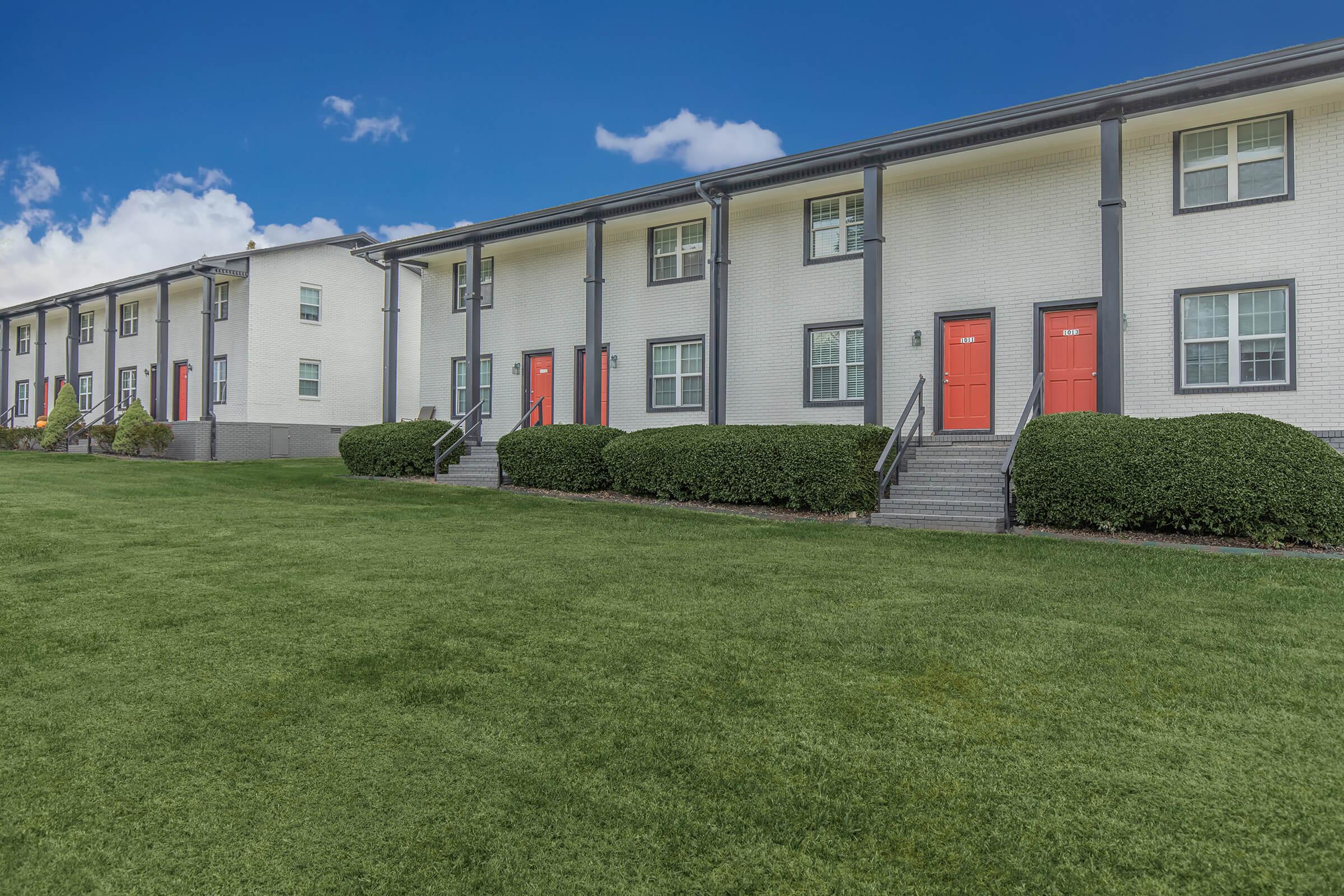 Set of two buildings of the Elements44 Townhomes and they're 2 Bed 1.5 Bath homes and it's beautiful landscape of bushes and green grass