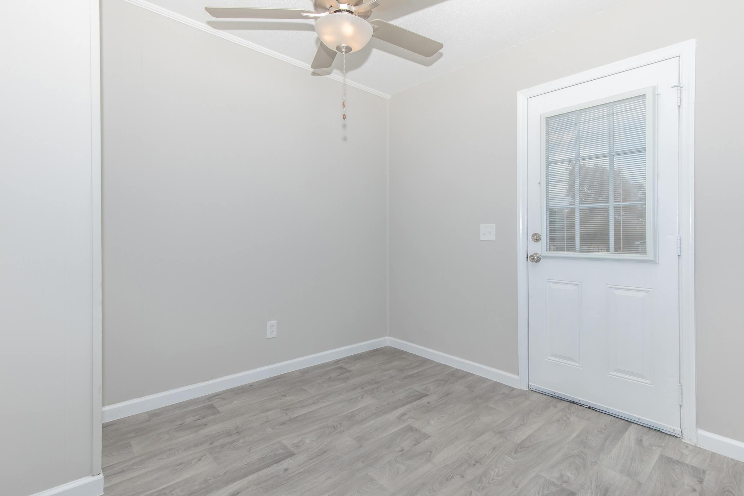 Elements44 Townhomes 2 Bed 1.5 Bath's back door with ceiling fan and hardwood floors