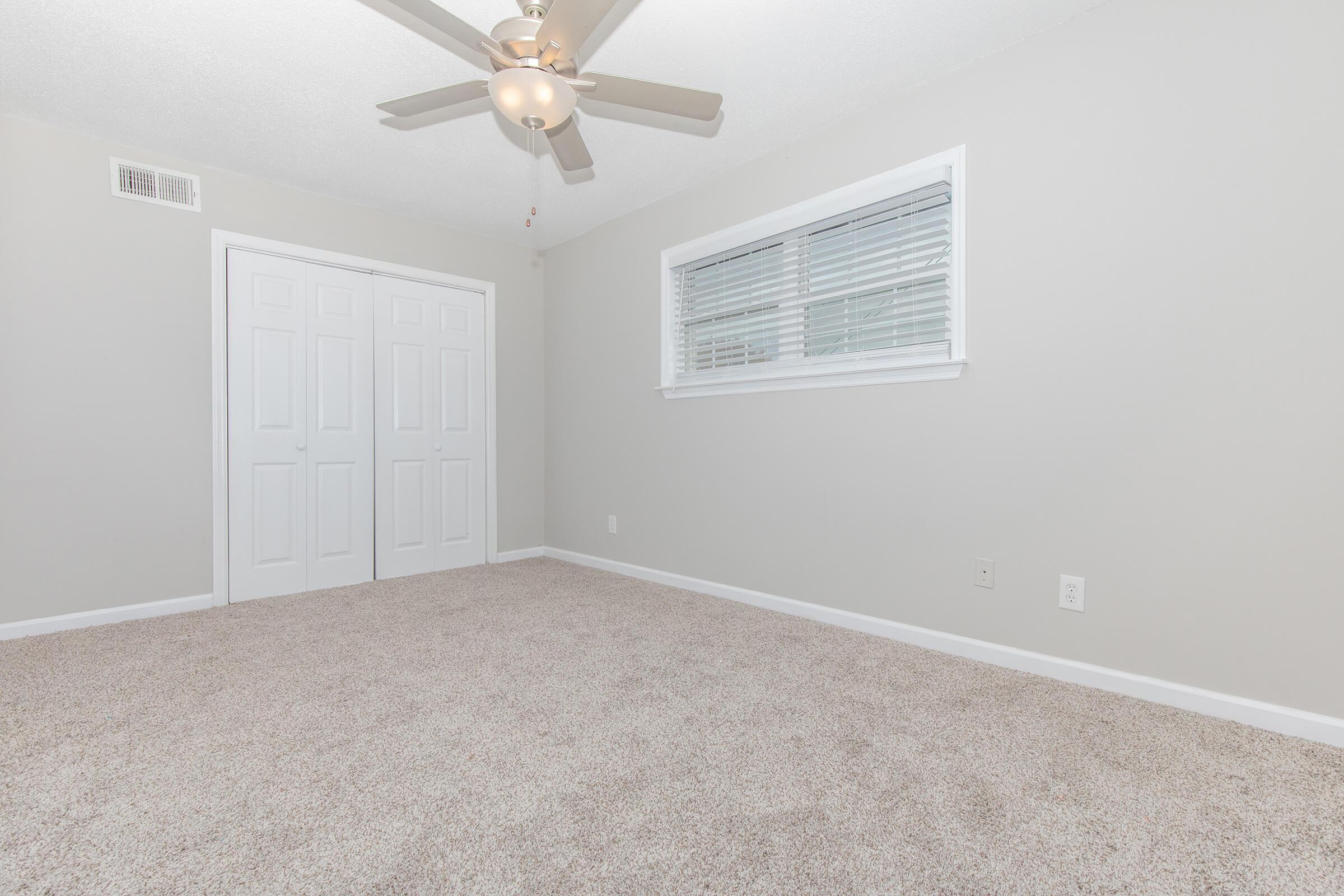 View one of the Elements44 Townhomes 2 Bed 1.5 bath homes with the carpeted floors, ceiling fans and closet doors