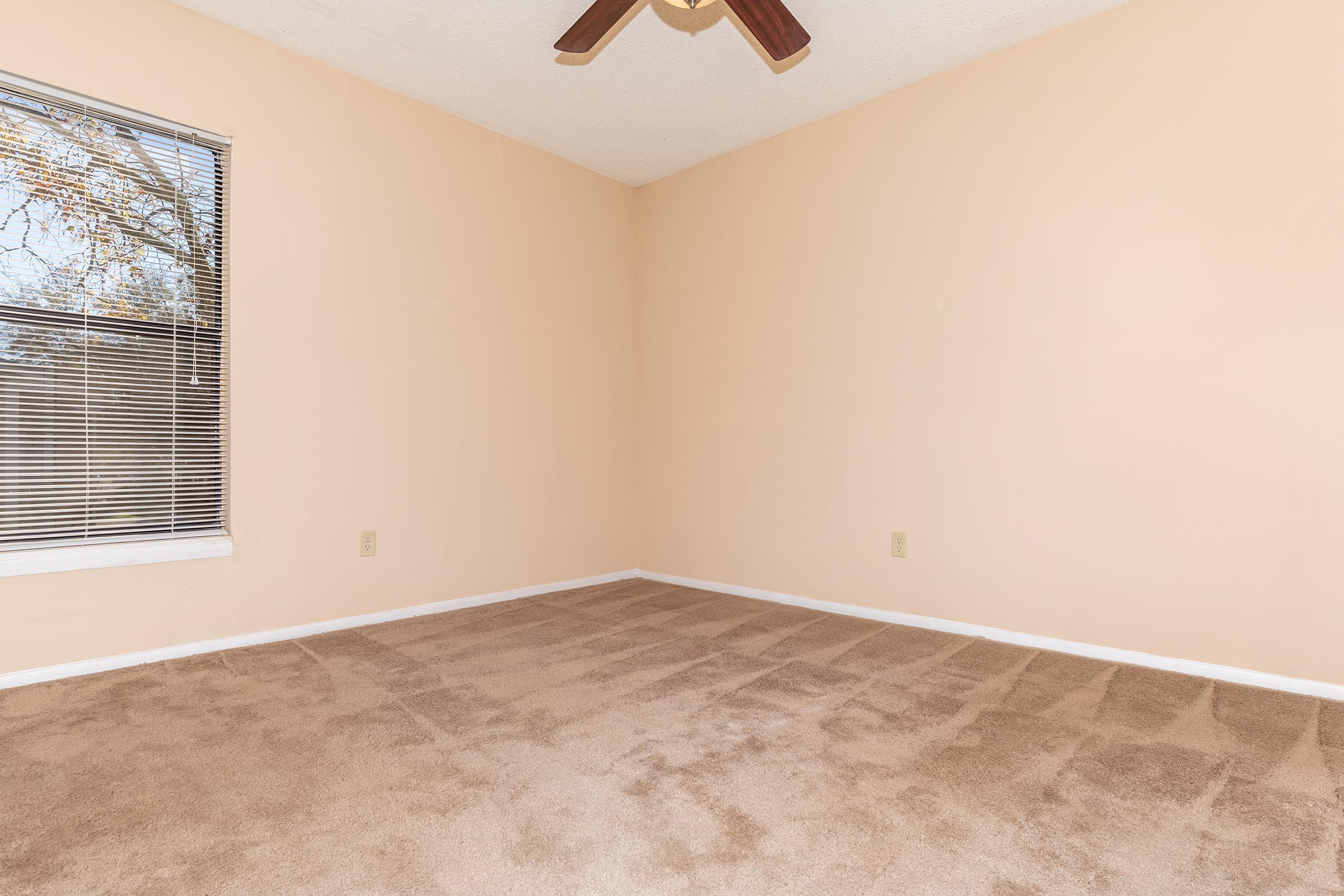 a bedroom with a large window
