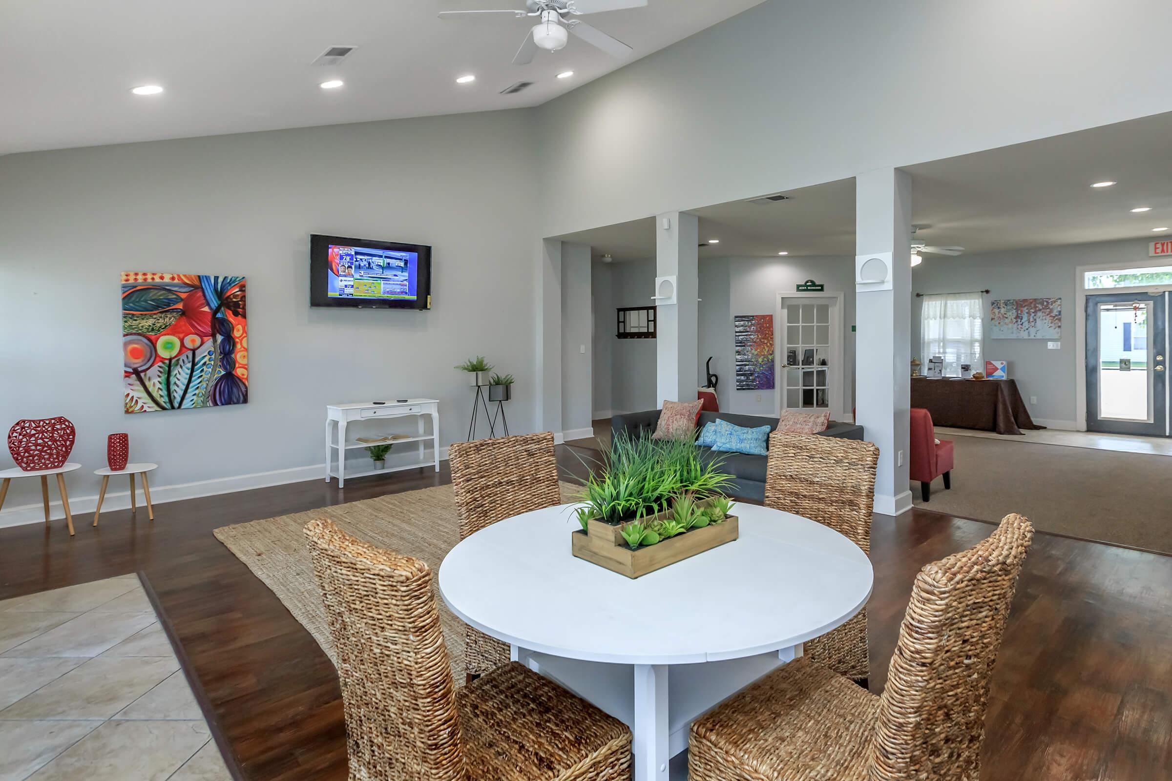 a living room filled with furniture and a flat screen tv