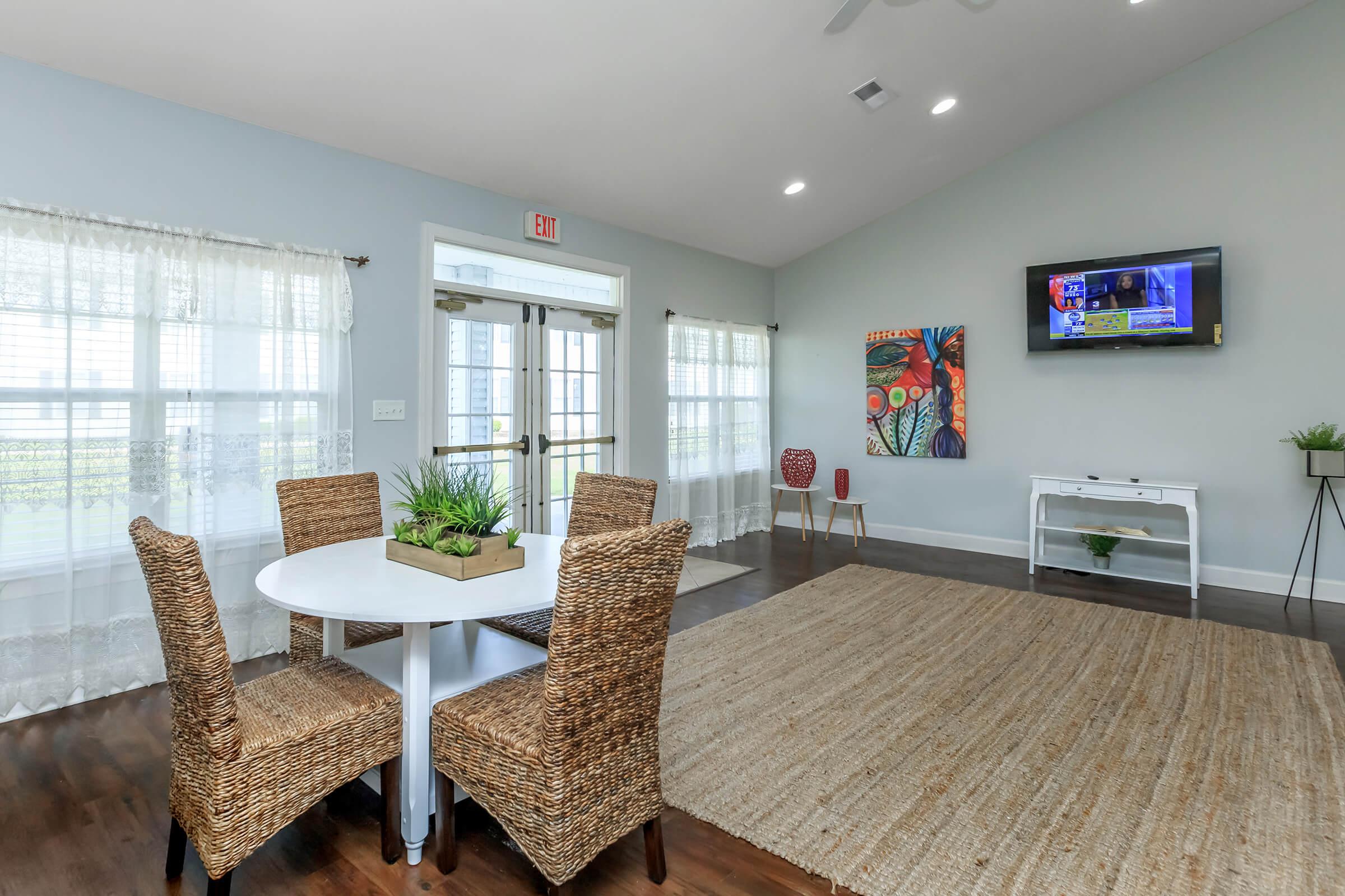 a living room filled with furniture and a large window