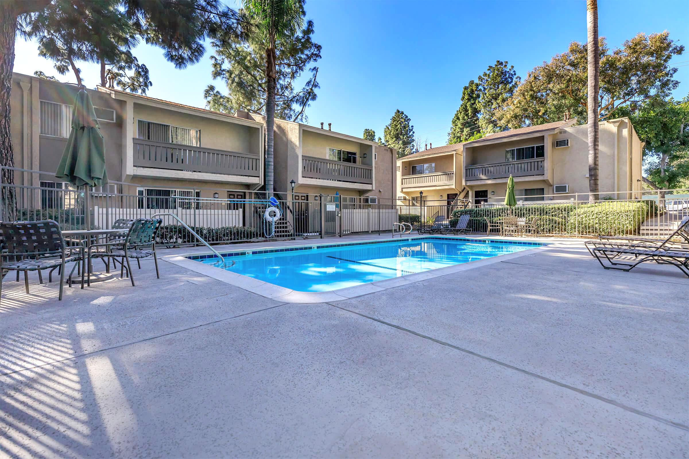 a house with a pool outside of a building