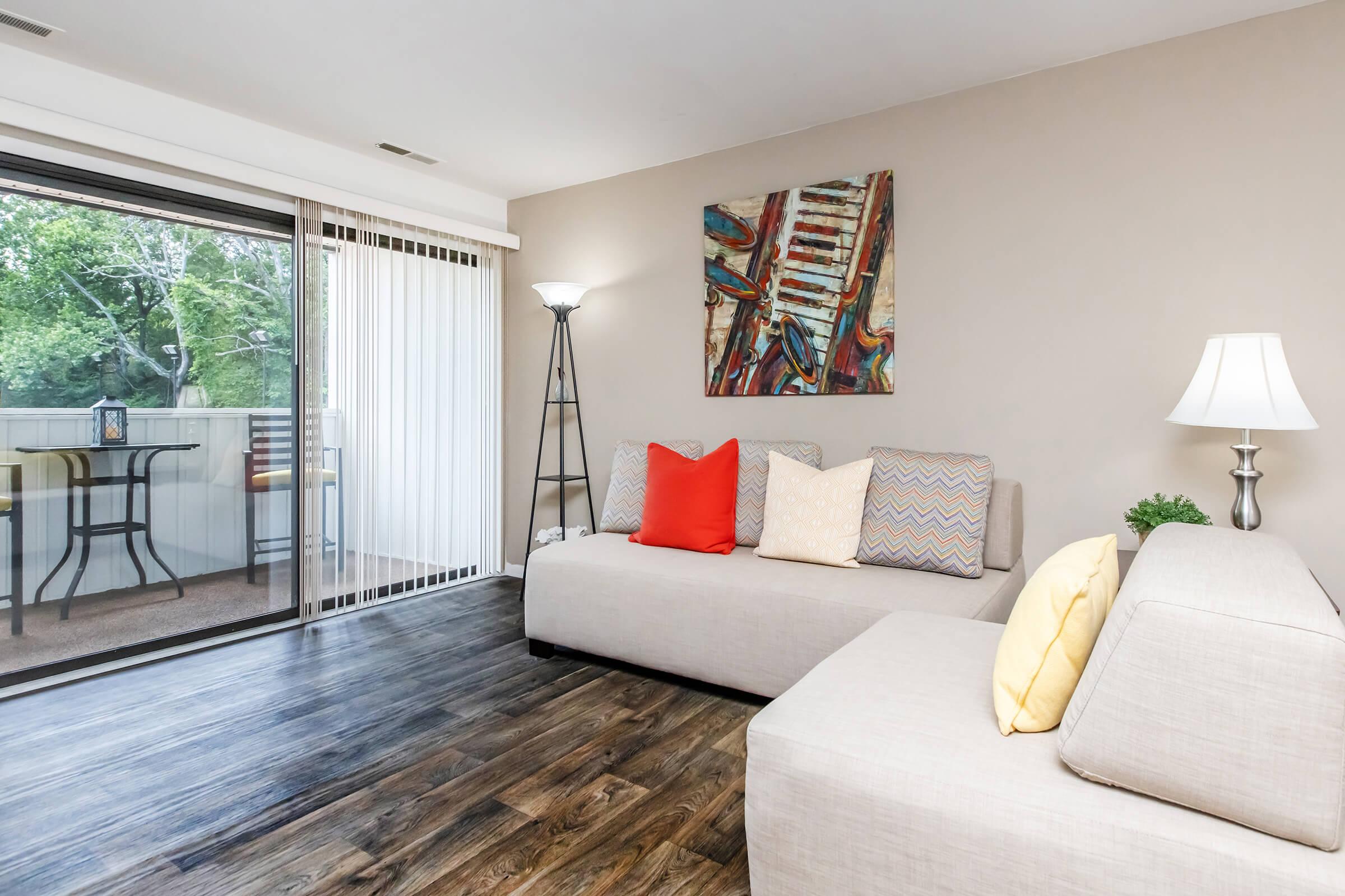 a bedroom with a bed and a couch in a living room