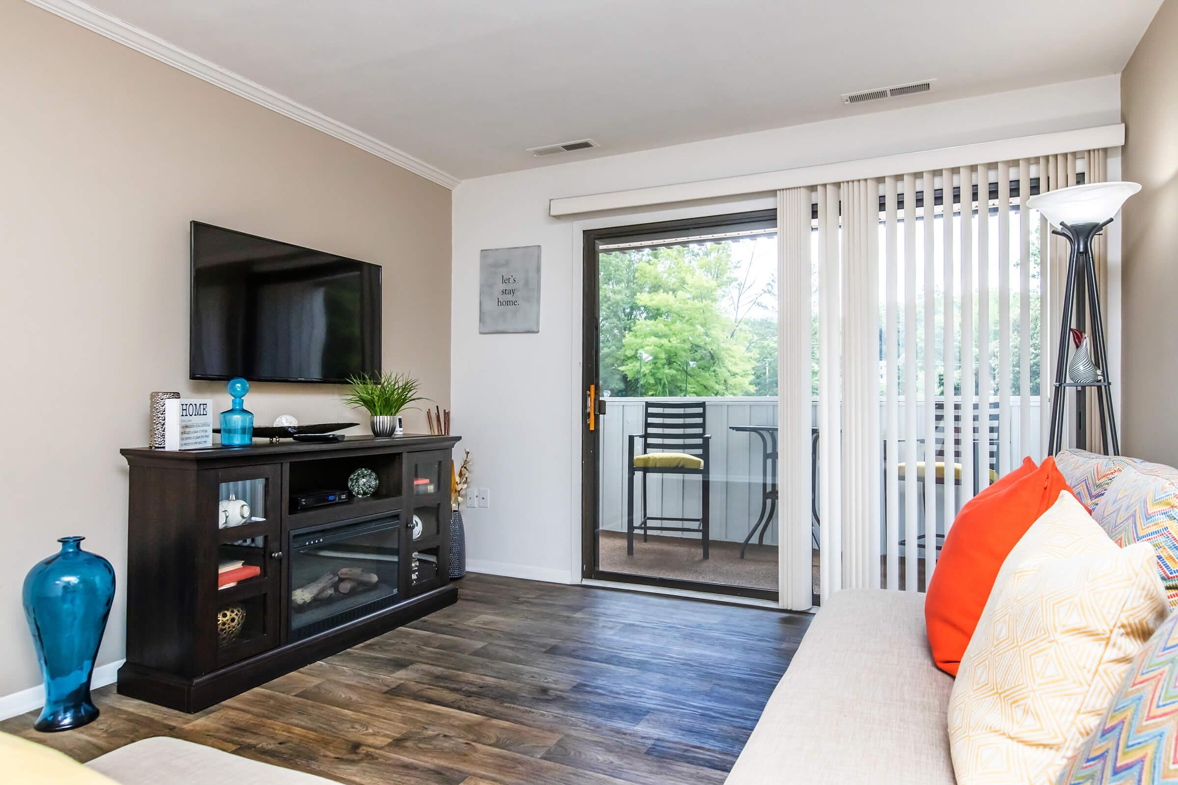 a living room filled with furniture and a flat screen tv