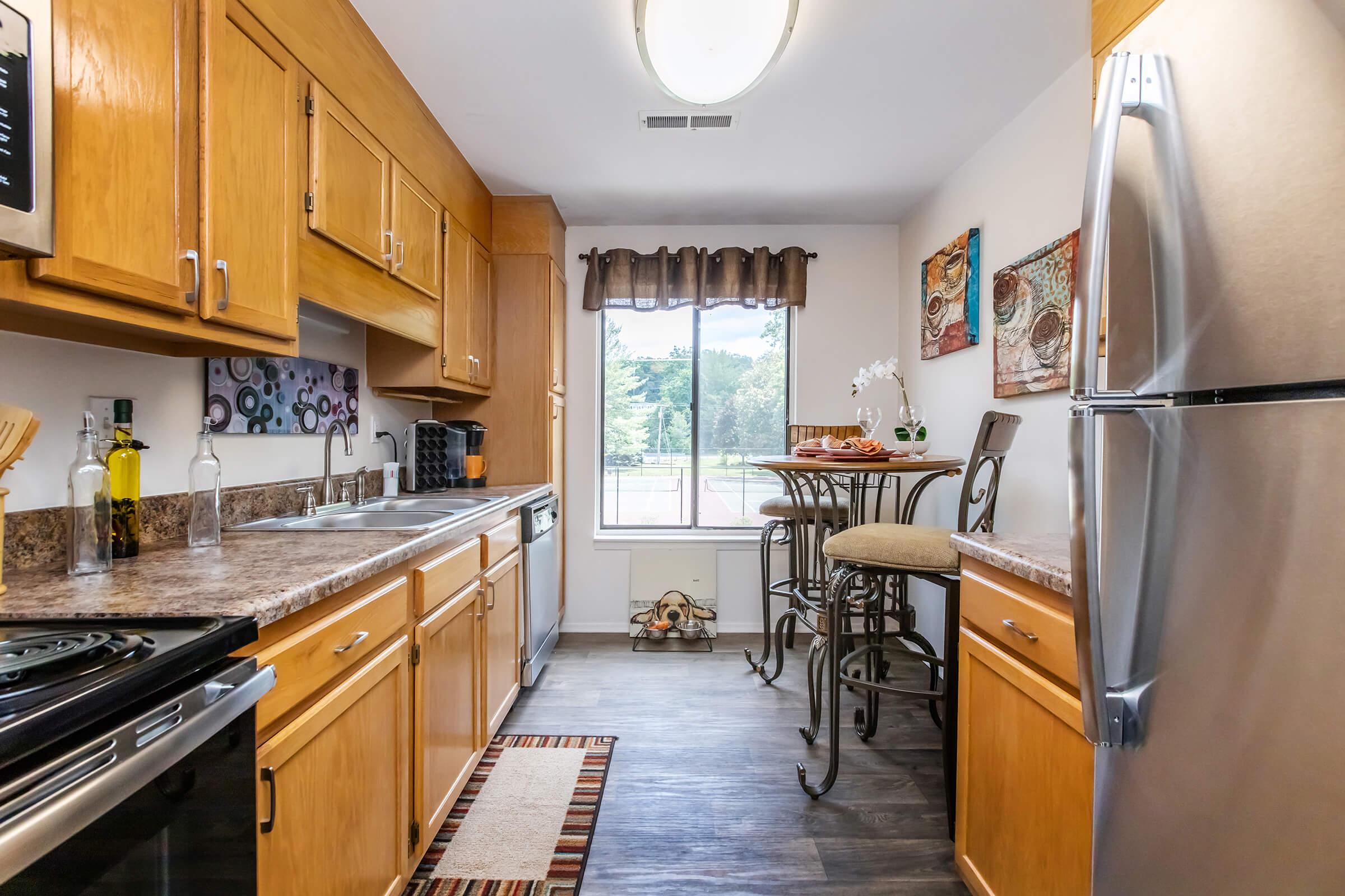 a modern kitchen with stainless steel appliances and wooden cabinets