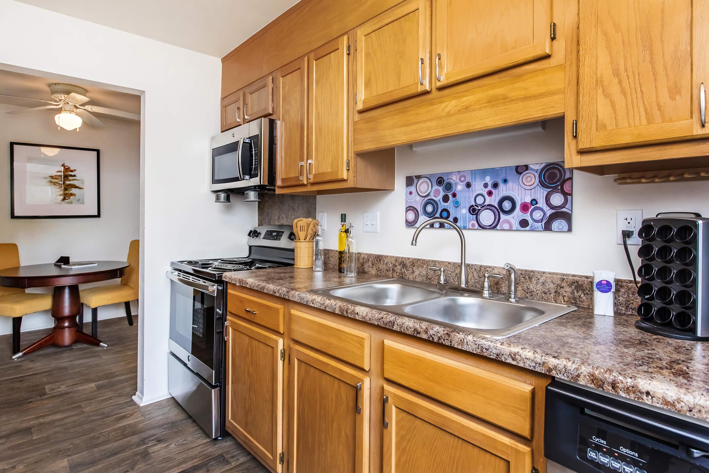 a kitchen with stainless steel appliances and wooden cabinets