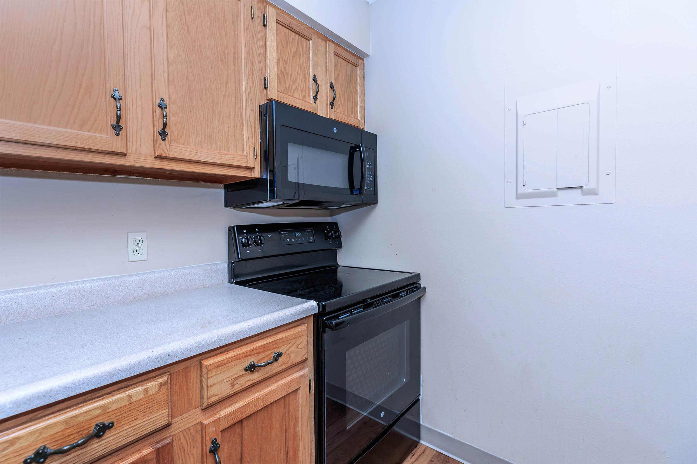 a stove top oven sitting inside of a kitchen