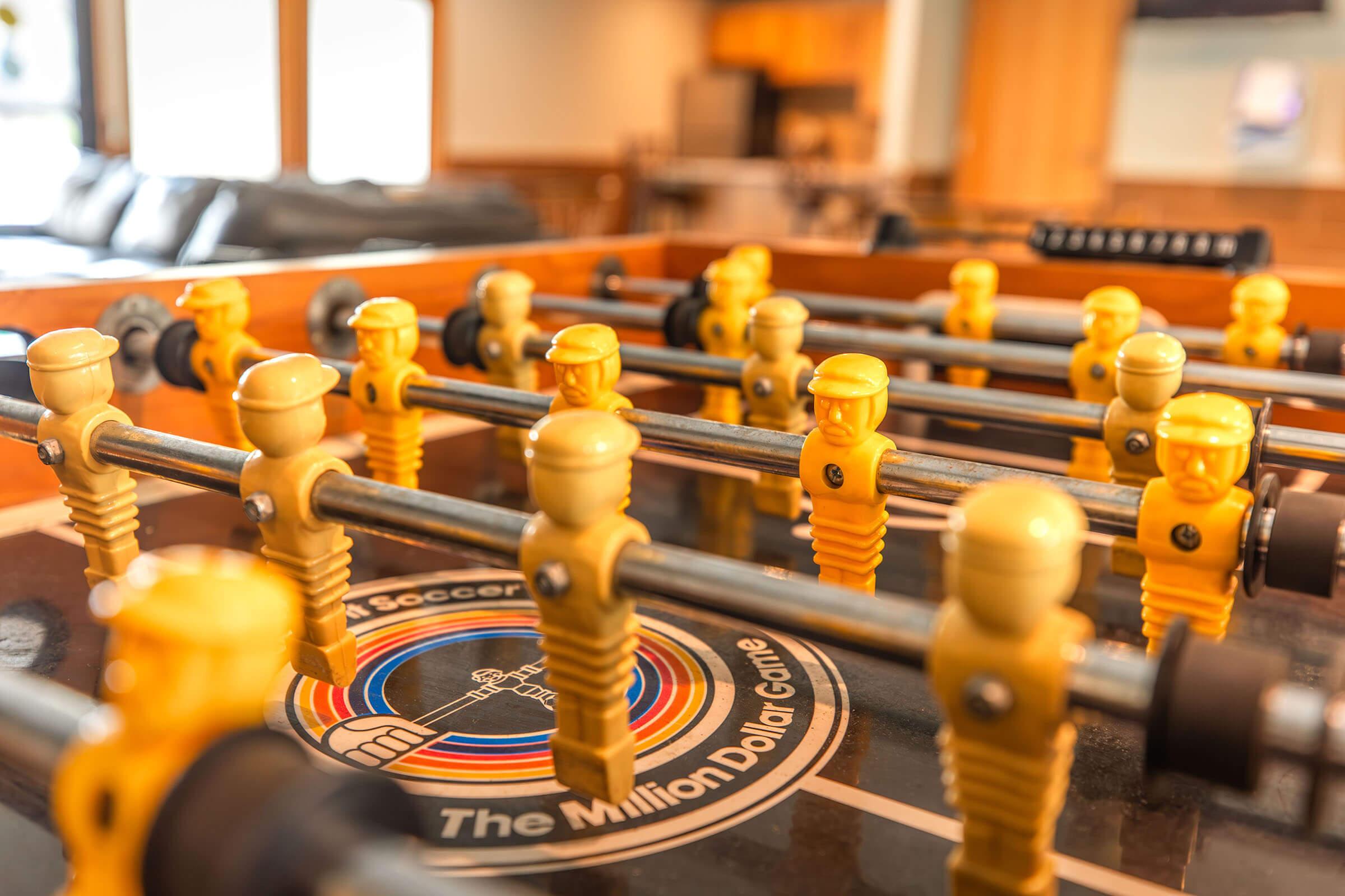 Resident clubhouse with foosball game table at Homewood Manor Apartments in Moline, IL