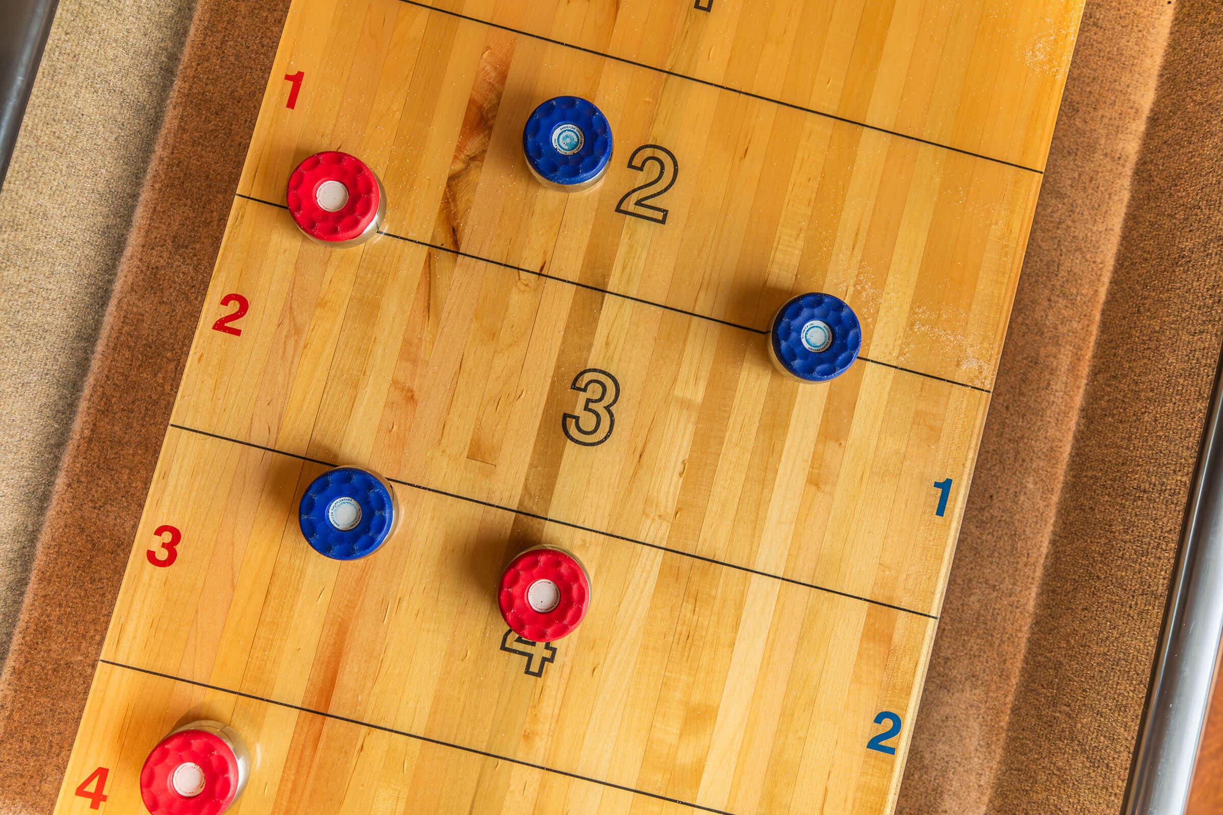 Shuffleboard game table inside resident clubhouse at Homewood Manor Apartments in Moline, IL