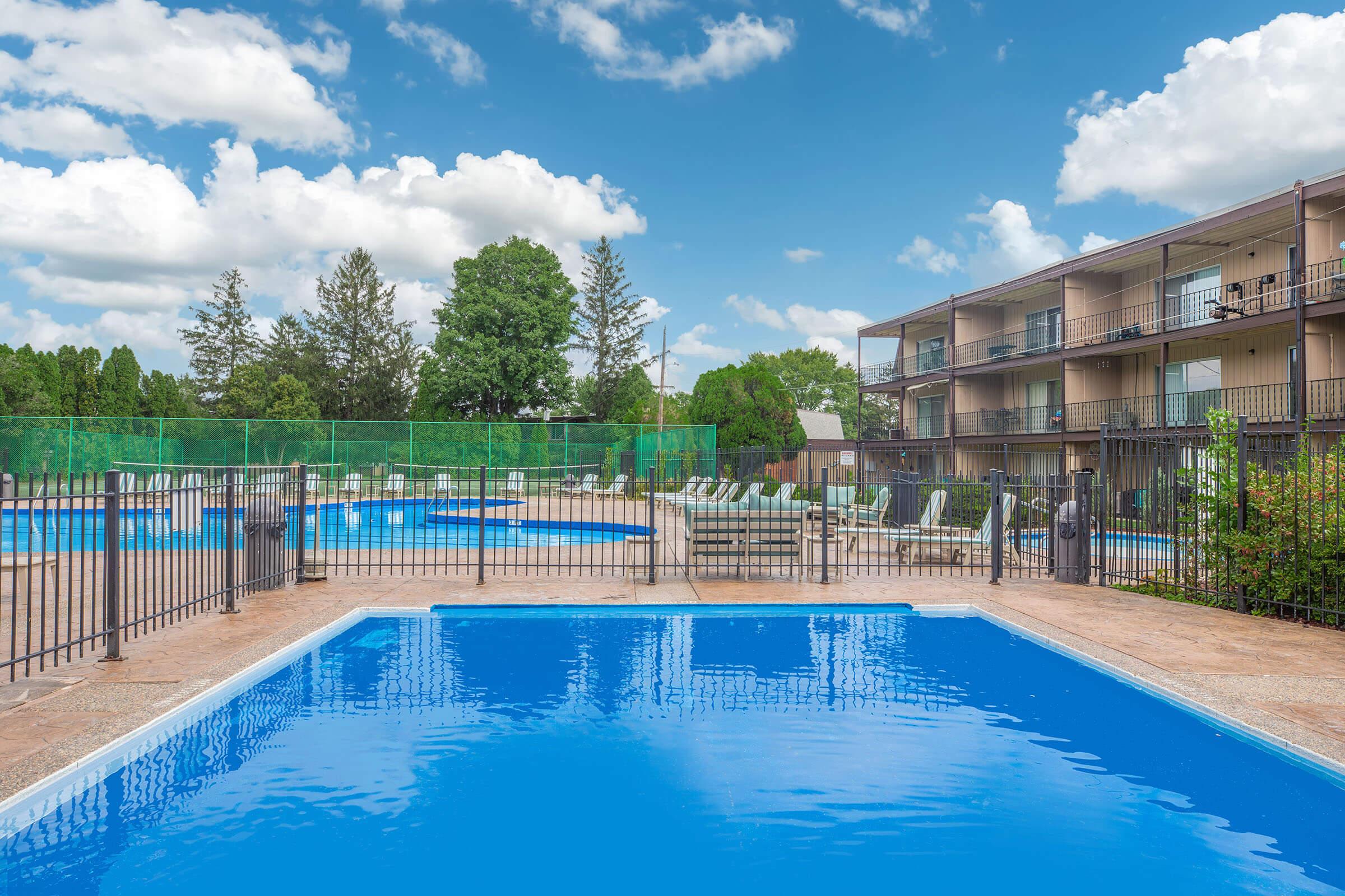 Outdoor swimming pool with safety fence at Homewood Manor Apartments in Moline, IL