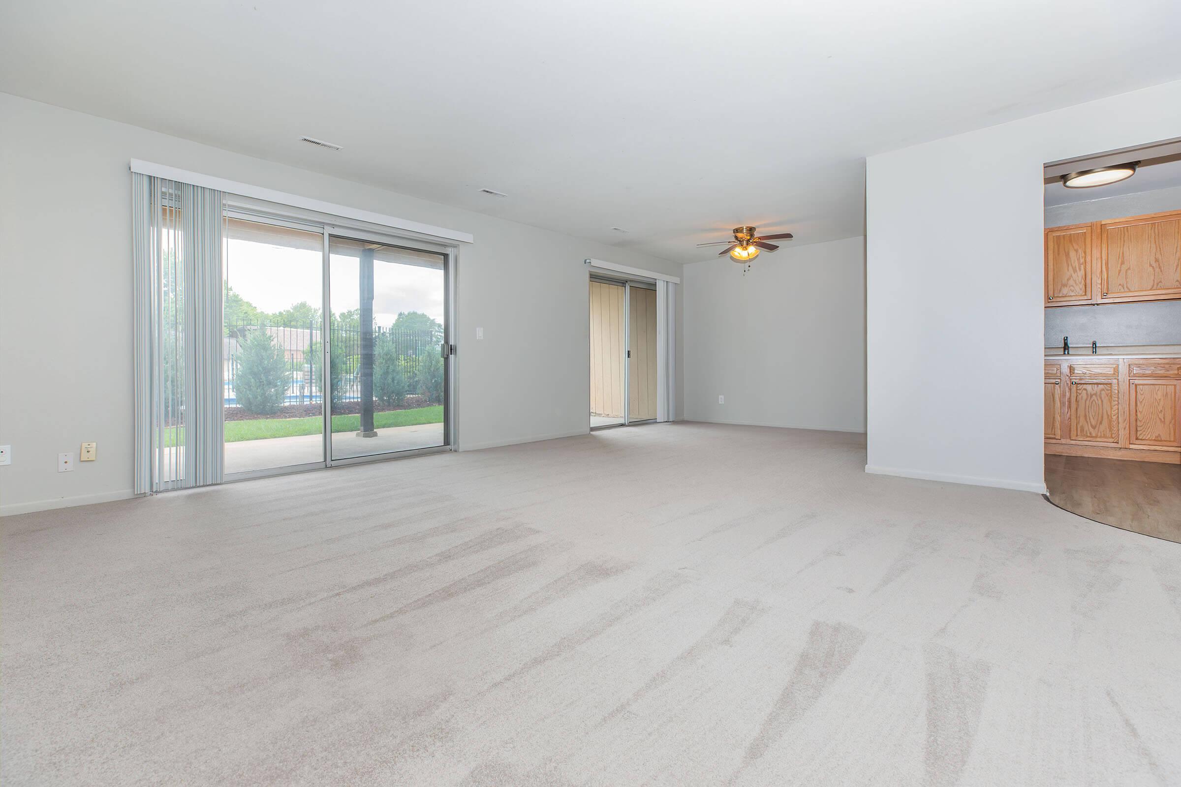 Spacious open living and dining area with natural light at Homewood Manor Apartments in Moline, IL