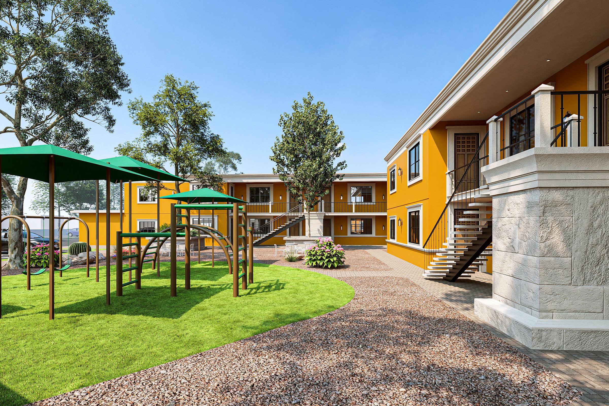 A bright, sunny courtyard featuring colorful yellow buildings. In the foreground, there is a playground with green canopies and climbing structures. Lush grass surrounds the area, while trees provide shade. The layout is inviting and designed for outdoor activities.