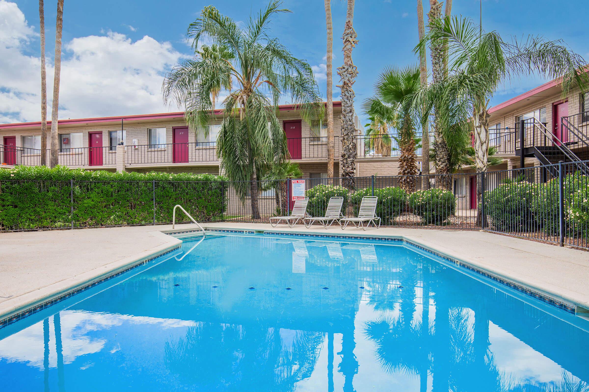 a house with a pool in front of a building