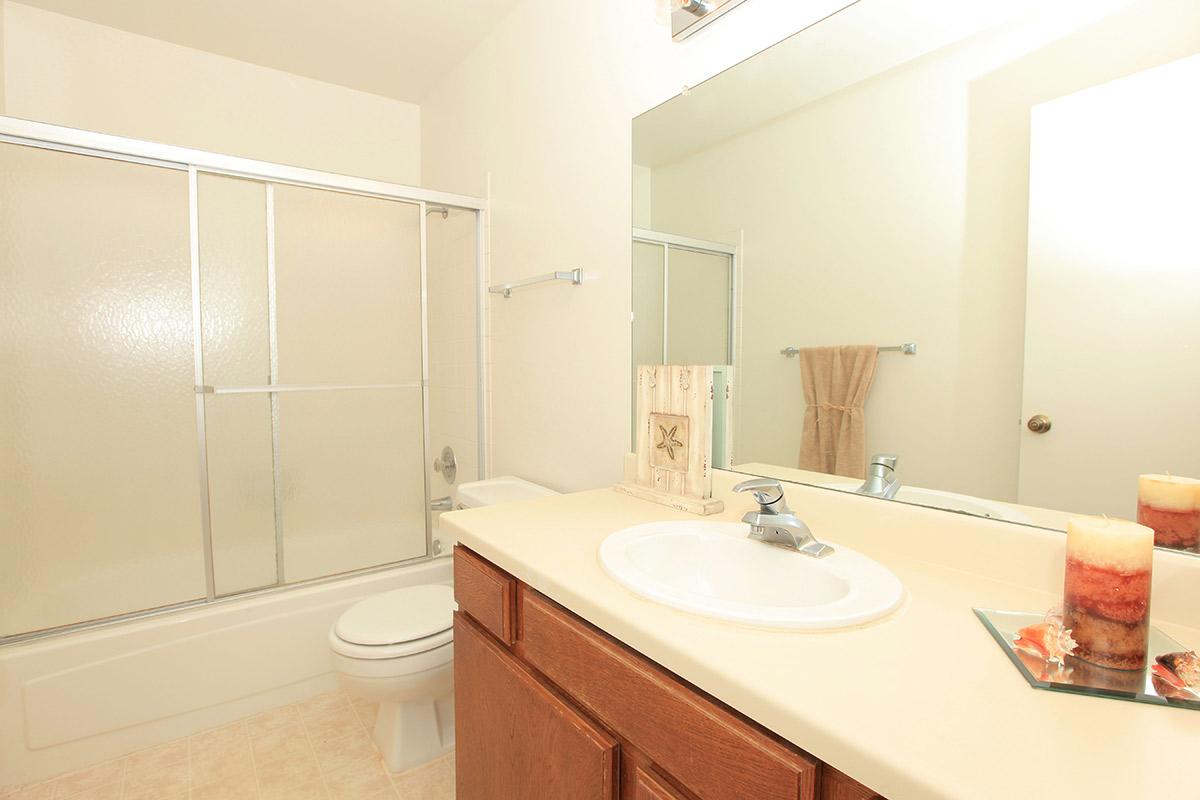 a large white tub sitting next to a sink