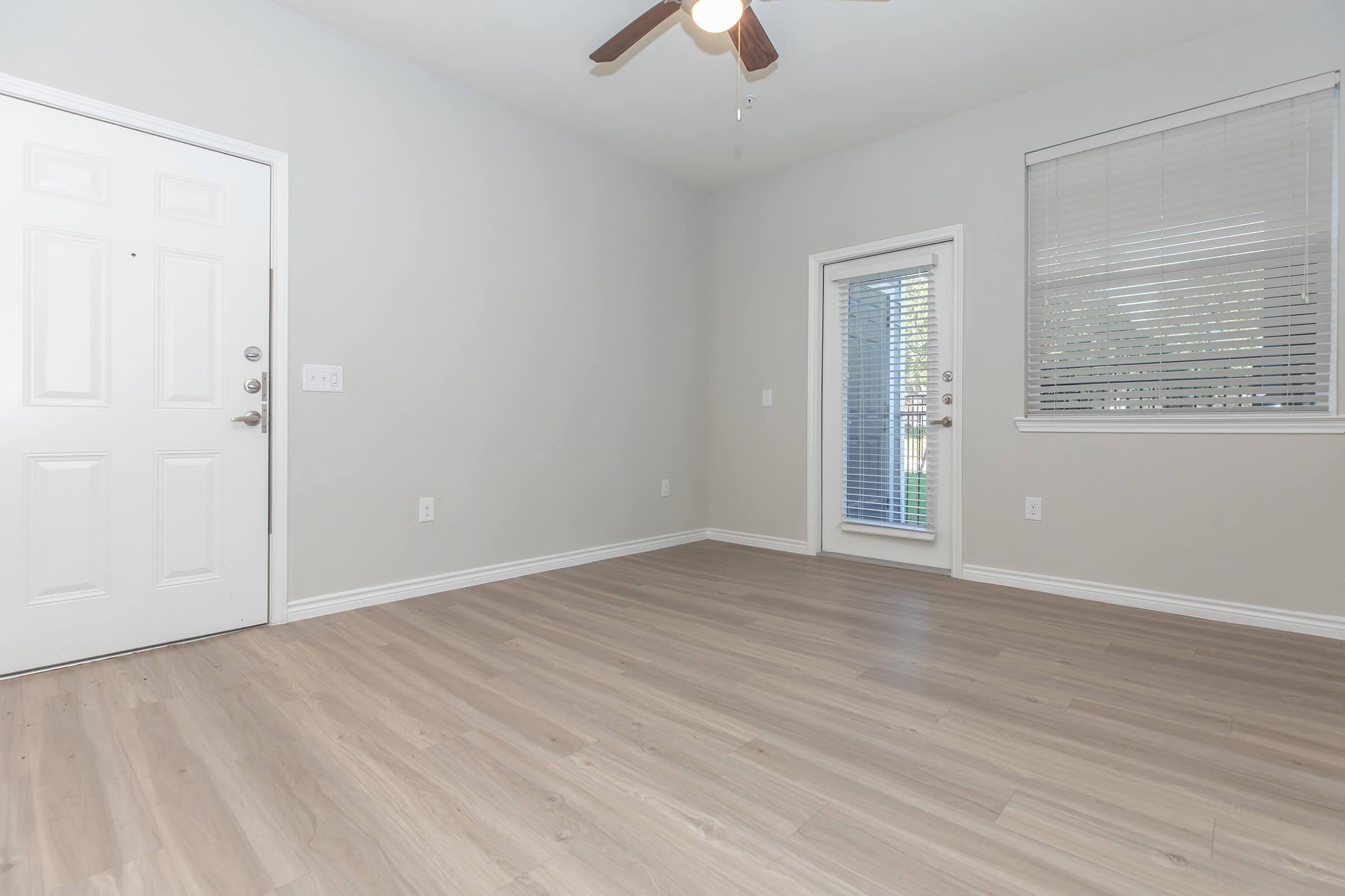 a close up of a hard wood floor next to a window