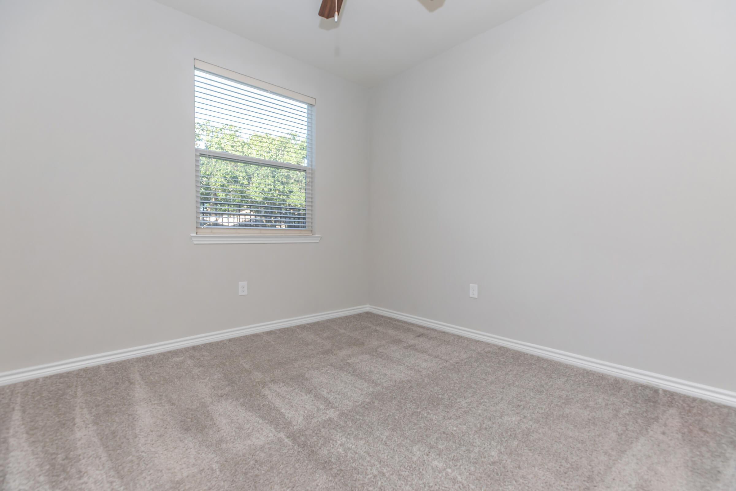 a bedroom with a large window