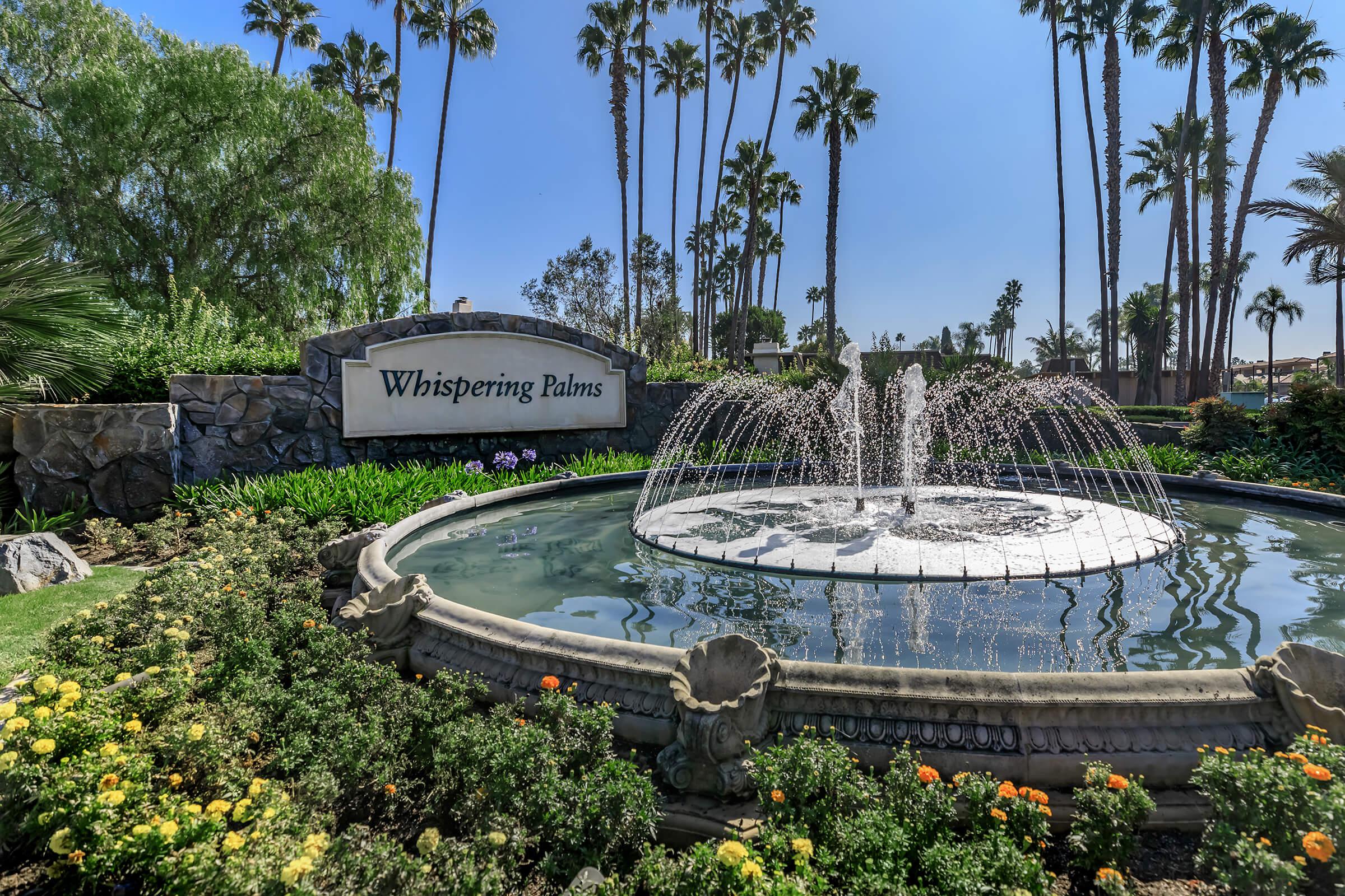 a garden with water in the background