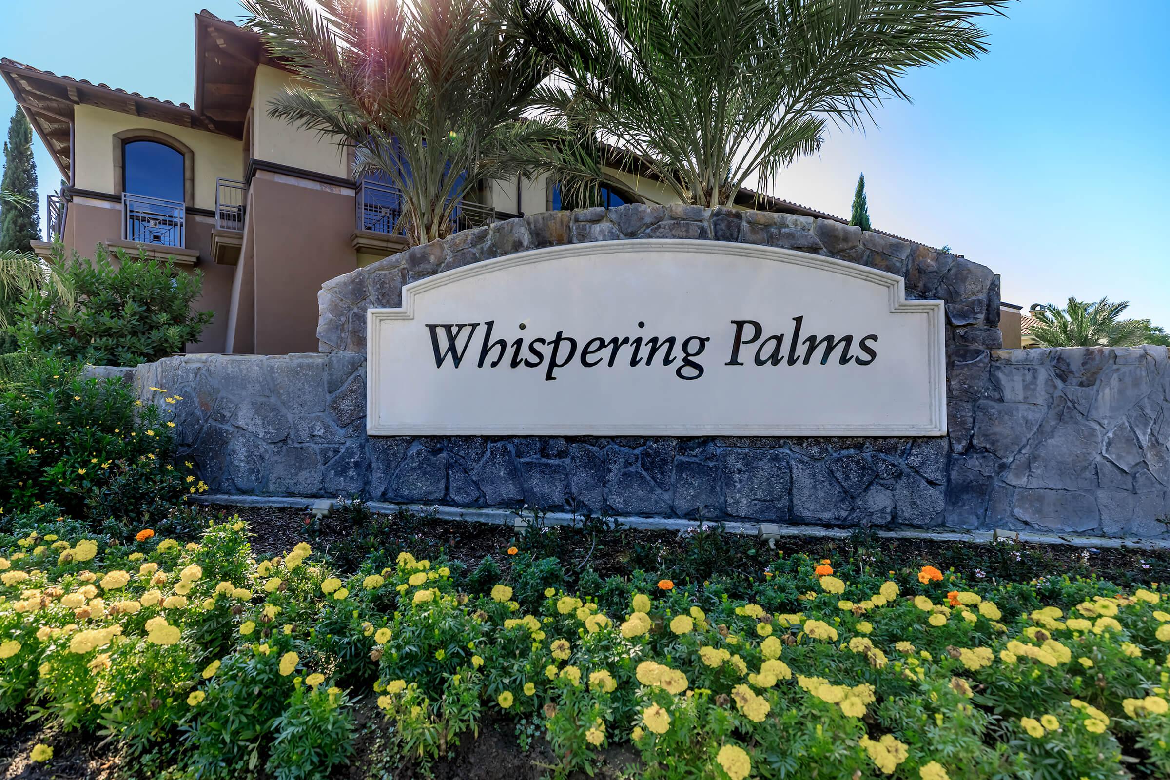 a close up of a flower garden in front of a building