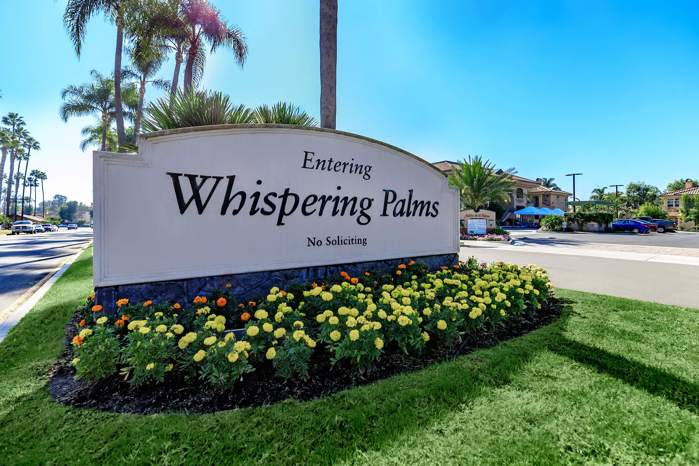 a close up of a flower garden in front of a sign