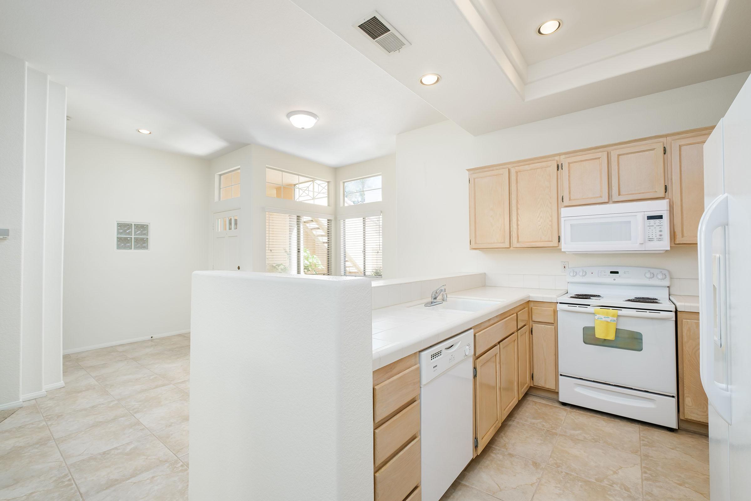 a white refrigerator freezer sitting inside of a kitchen