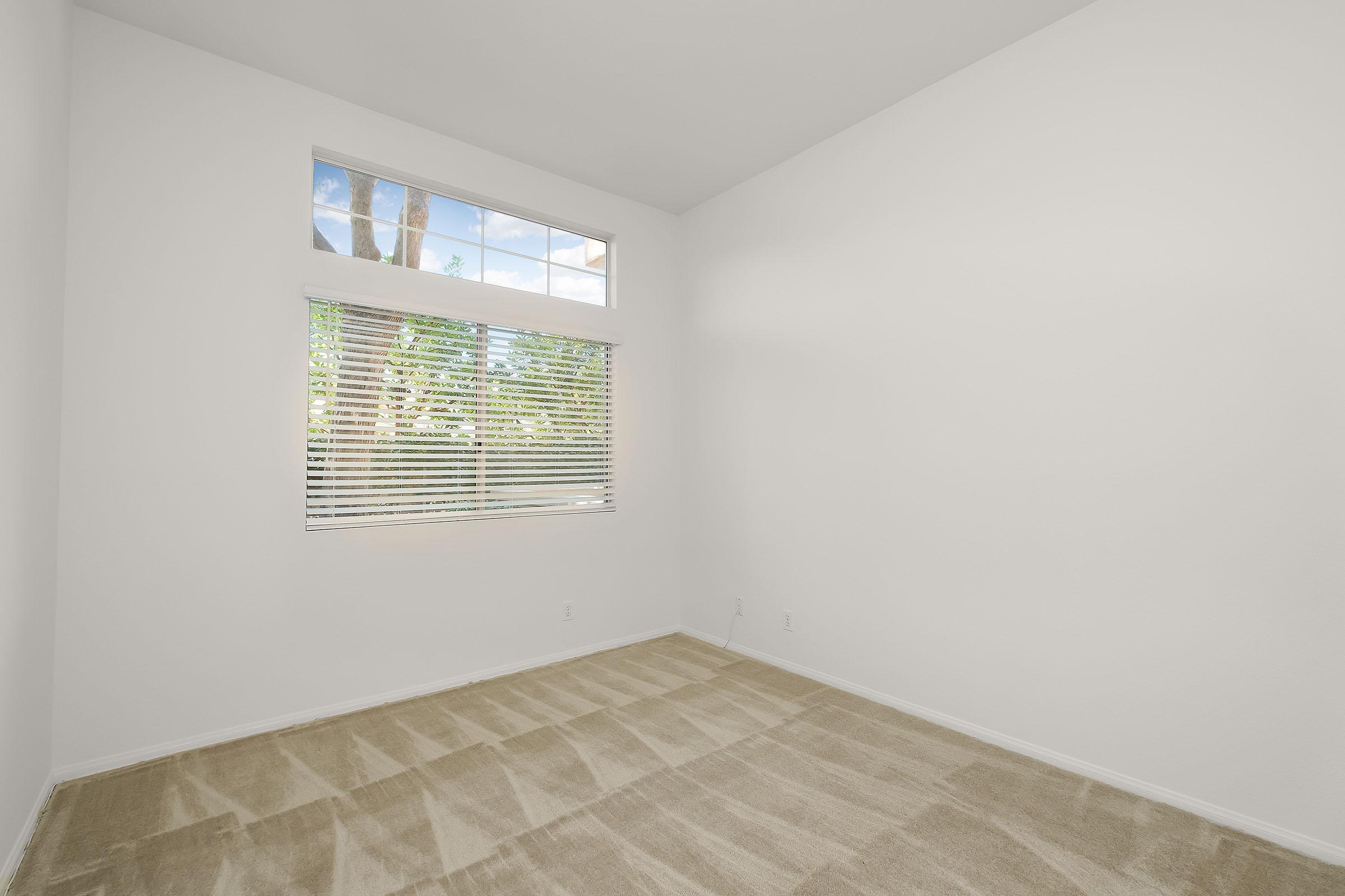 a bedroom with a large window