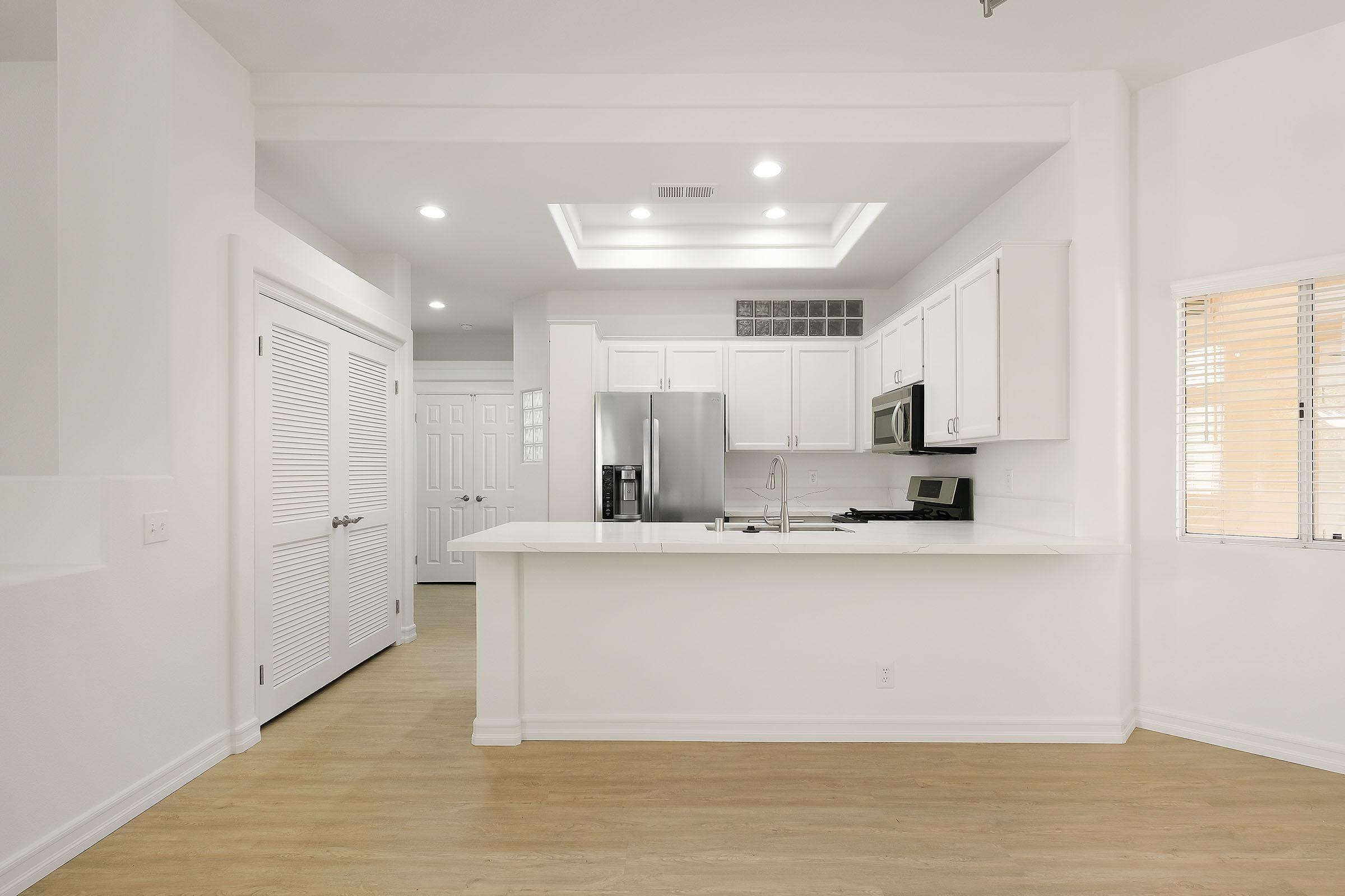 a kitchen with a sink and a refrigerator