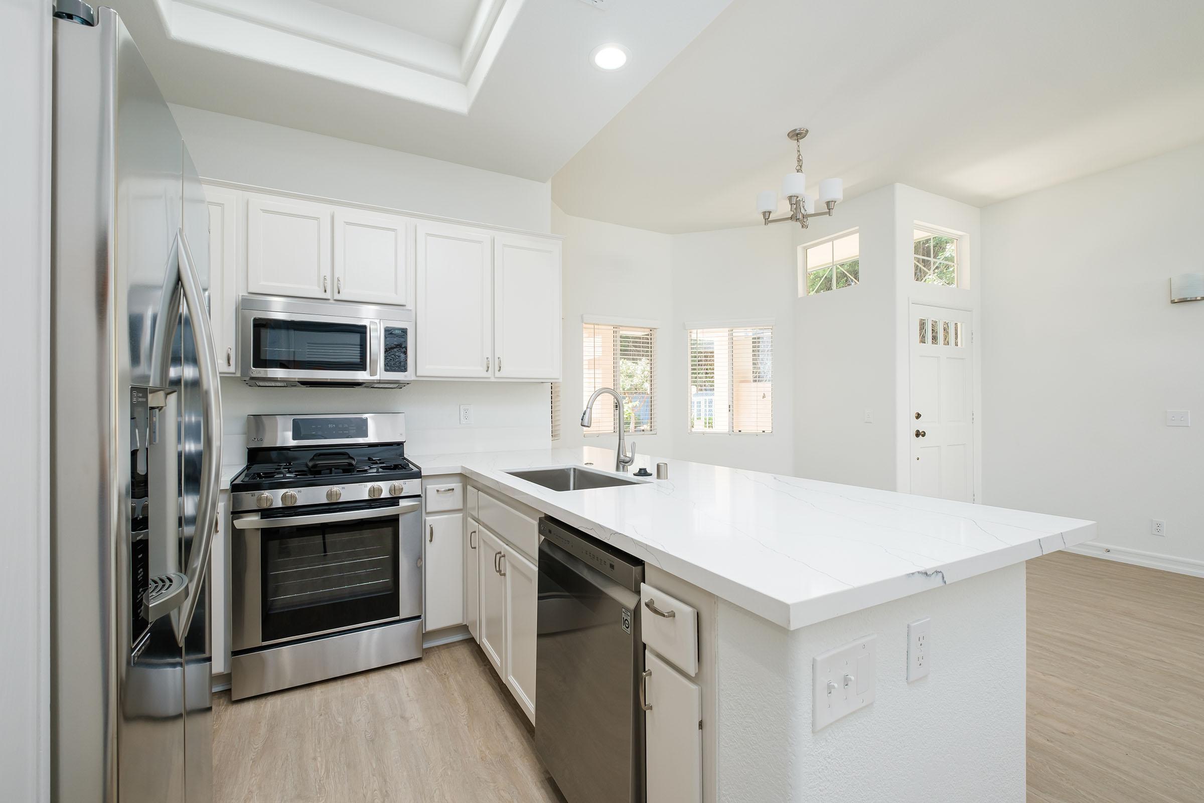 a kitchen with a stove sink and refrigerator