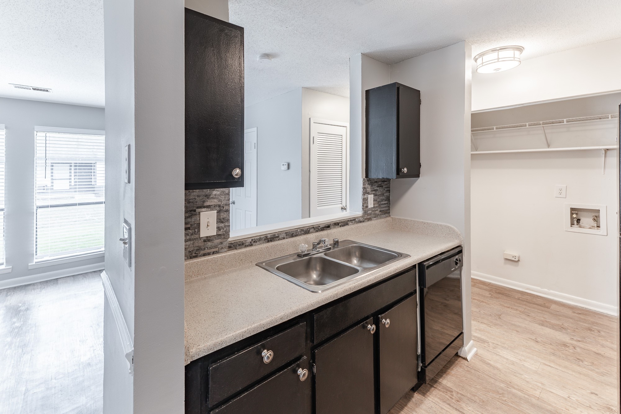 a kitchen with a sink and a mirror