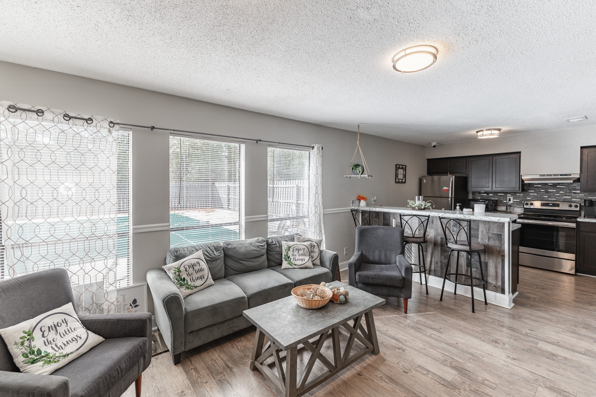 a living room filled with furniture and a large window