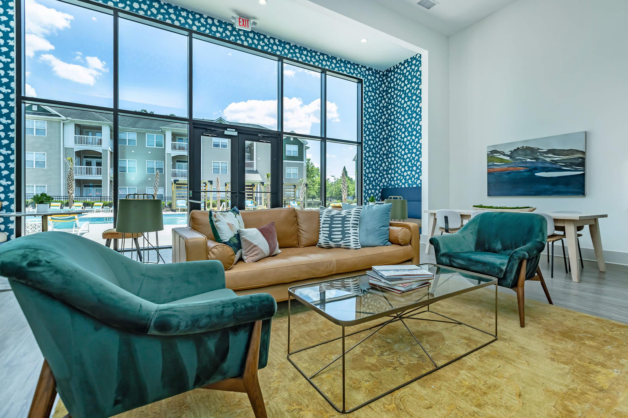 a living room filled with furniture and a large window