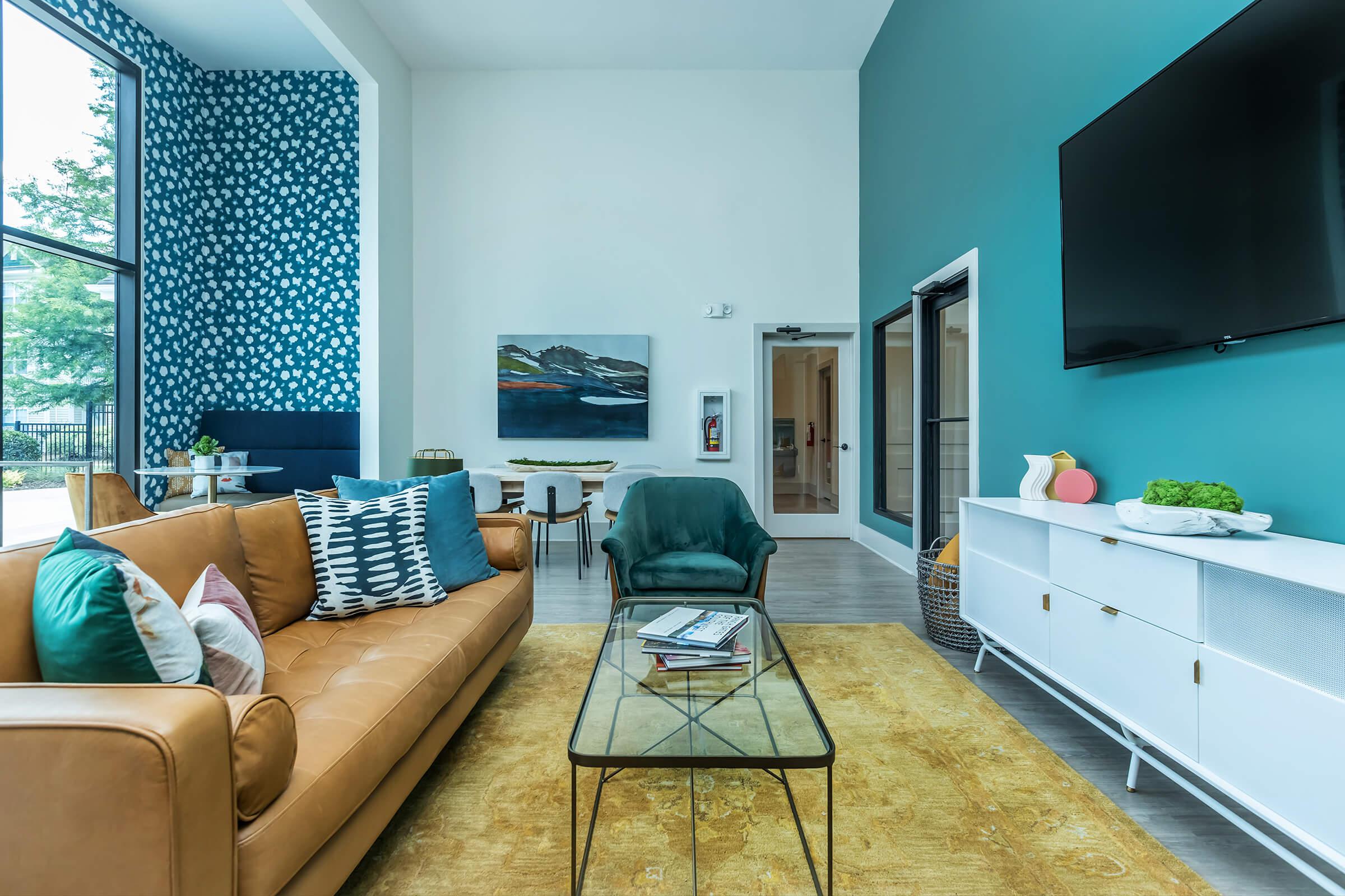 a living room filled with furniture and a large window