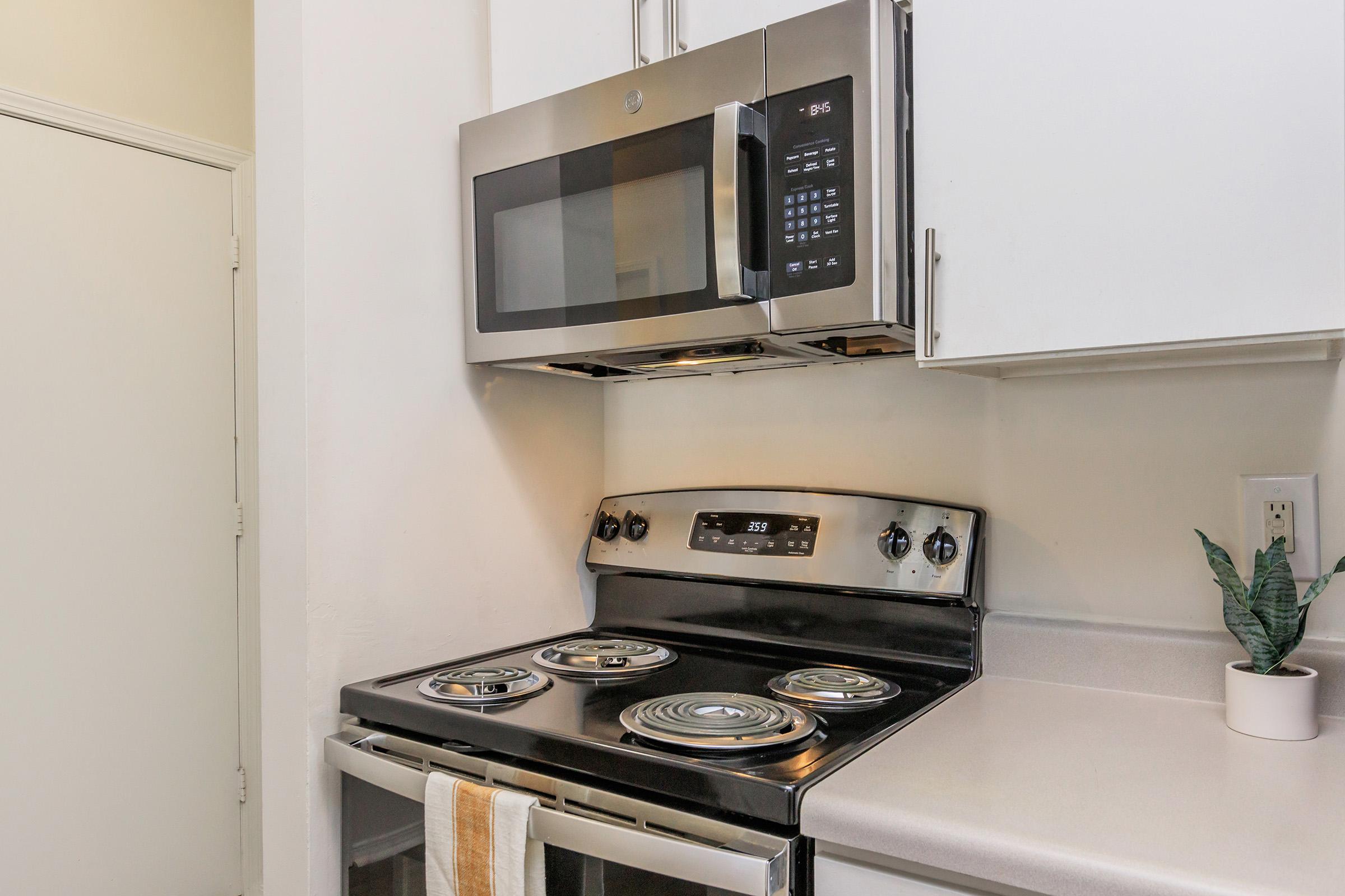 a stove top oven sitting inside of a kitchen