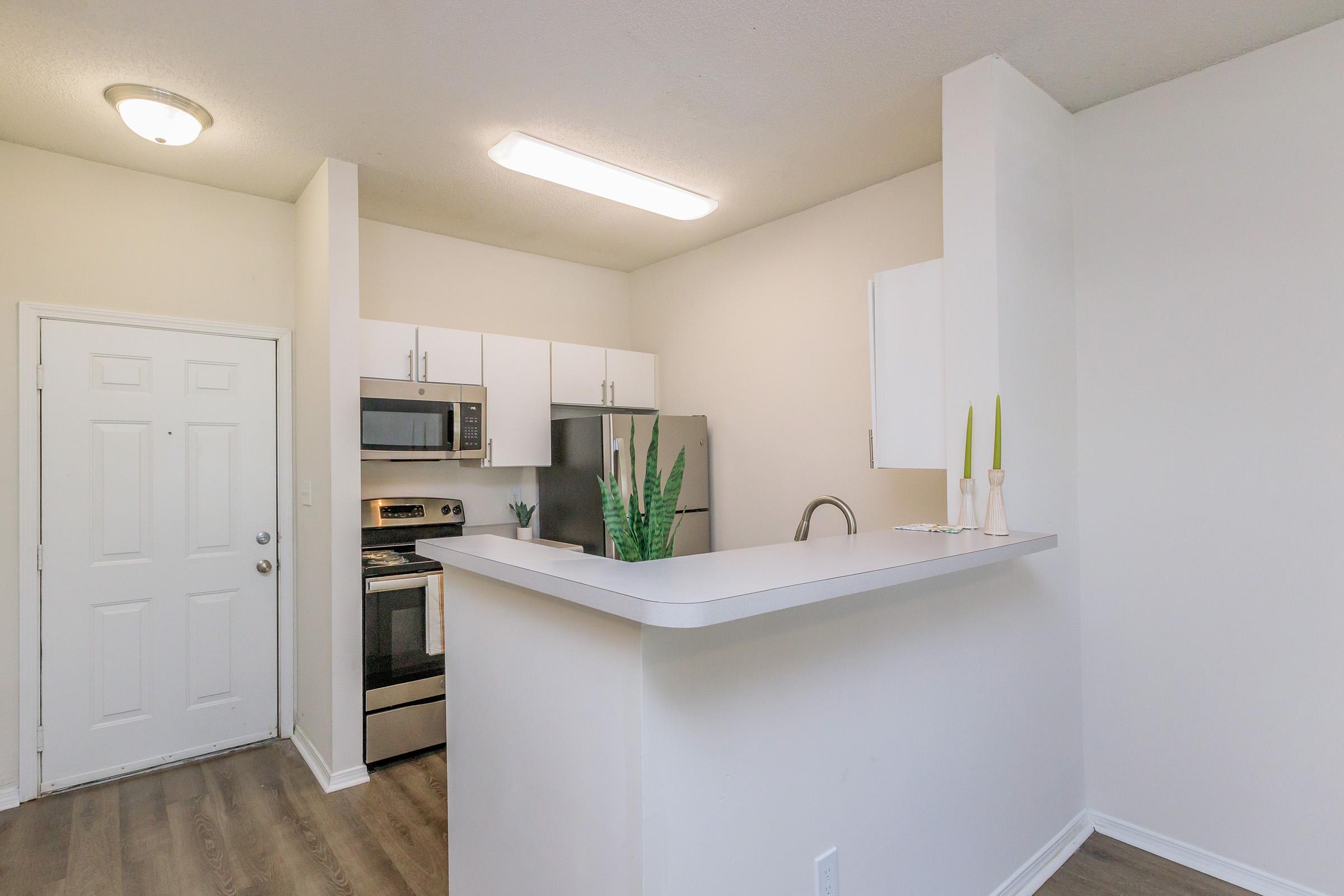 a kitchen with a sink and a mirror