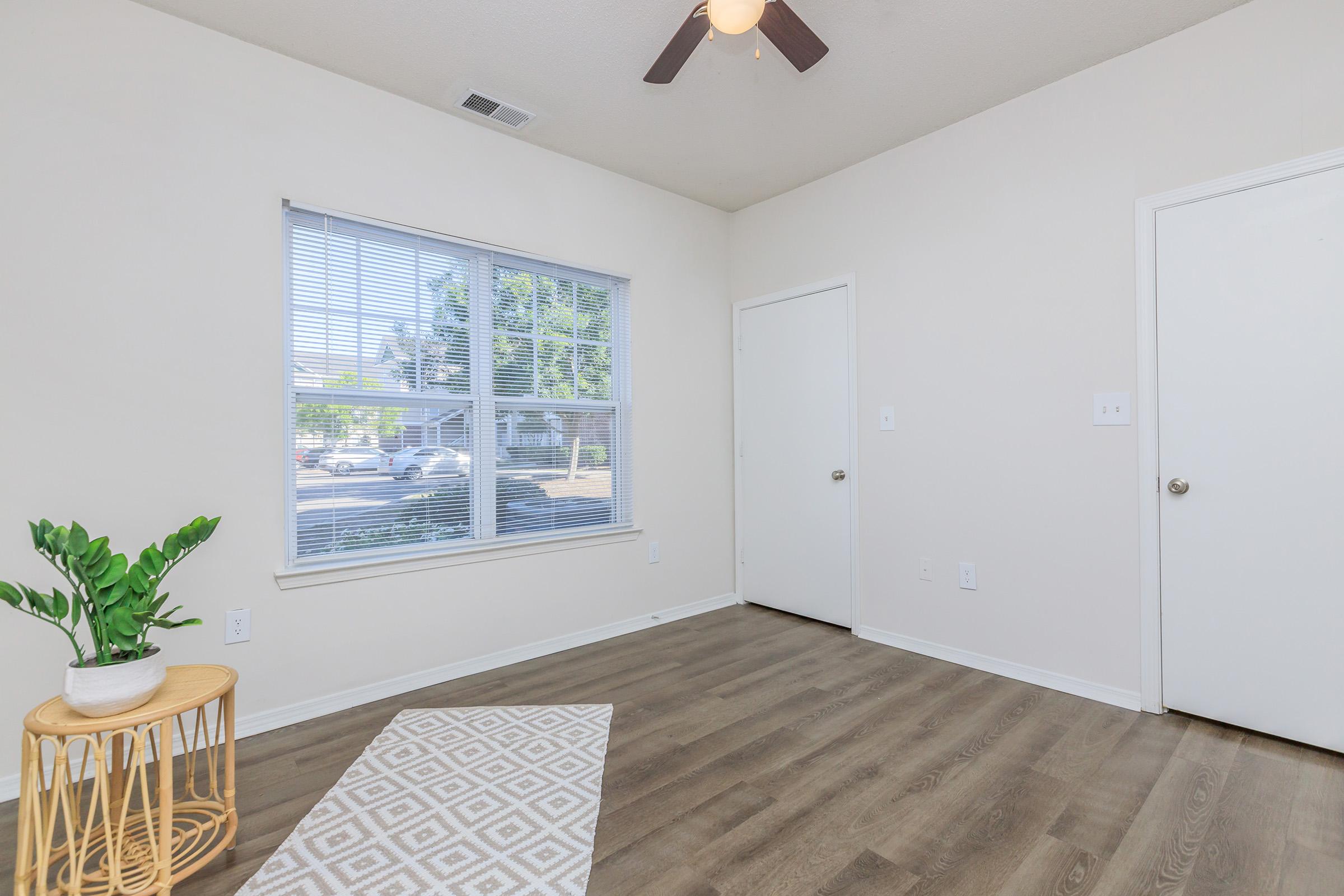 a room filled with furniture and a large window